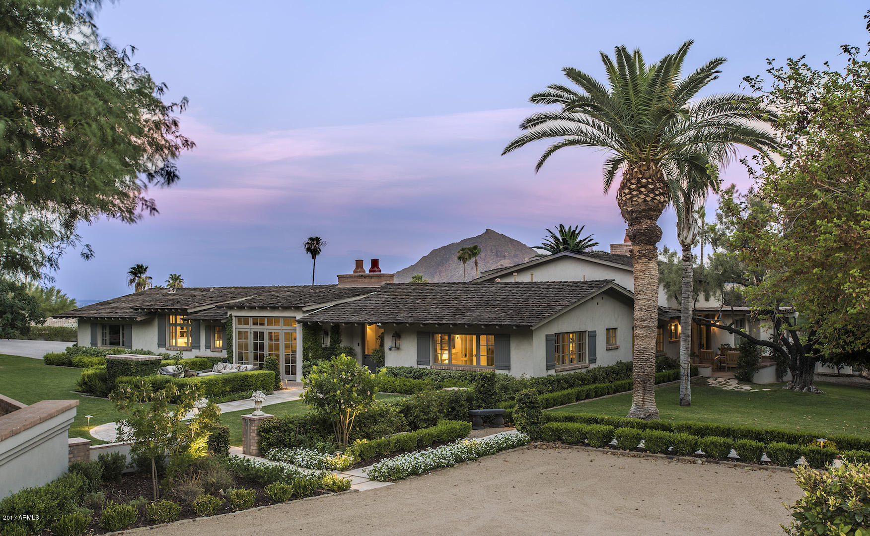 You will be awe-inspired from the moment you walk through the stately courtyard of this Country French estate. Sprawling manicured grounds with charming sitting areas await you around every corner. Upon entering through your Dutch front door, you will enjoy a single level floor plan of open entertaining spaces and private guest suites. Every single room captures the stunning mountain views and serenity this home has to offer. Jacque Pepin would die to cook in this gorgeous kitchen! Complete with walk-in refrigerator, Calcutta Marble countertops, Sub-Zero Wolf double ovens, commercial Wolf gas range, butlers pantry, and charming gas fireplace make this the perfect place for family gatherings. Dining room & office features 100-year-old beams shipped in from a Pennsylvania barn. Jump into a 50m-heated lap pool for an afternoon swim while capturing the sunsets over Camelback Mountain. This home was completely renovated by Mark Candelaria and Andra Miller designs in 2014 with not one detailed missed. Truly a one-of-a-kind property you will not want to miss!