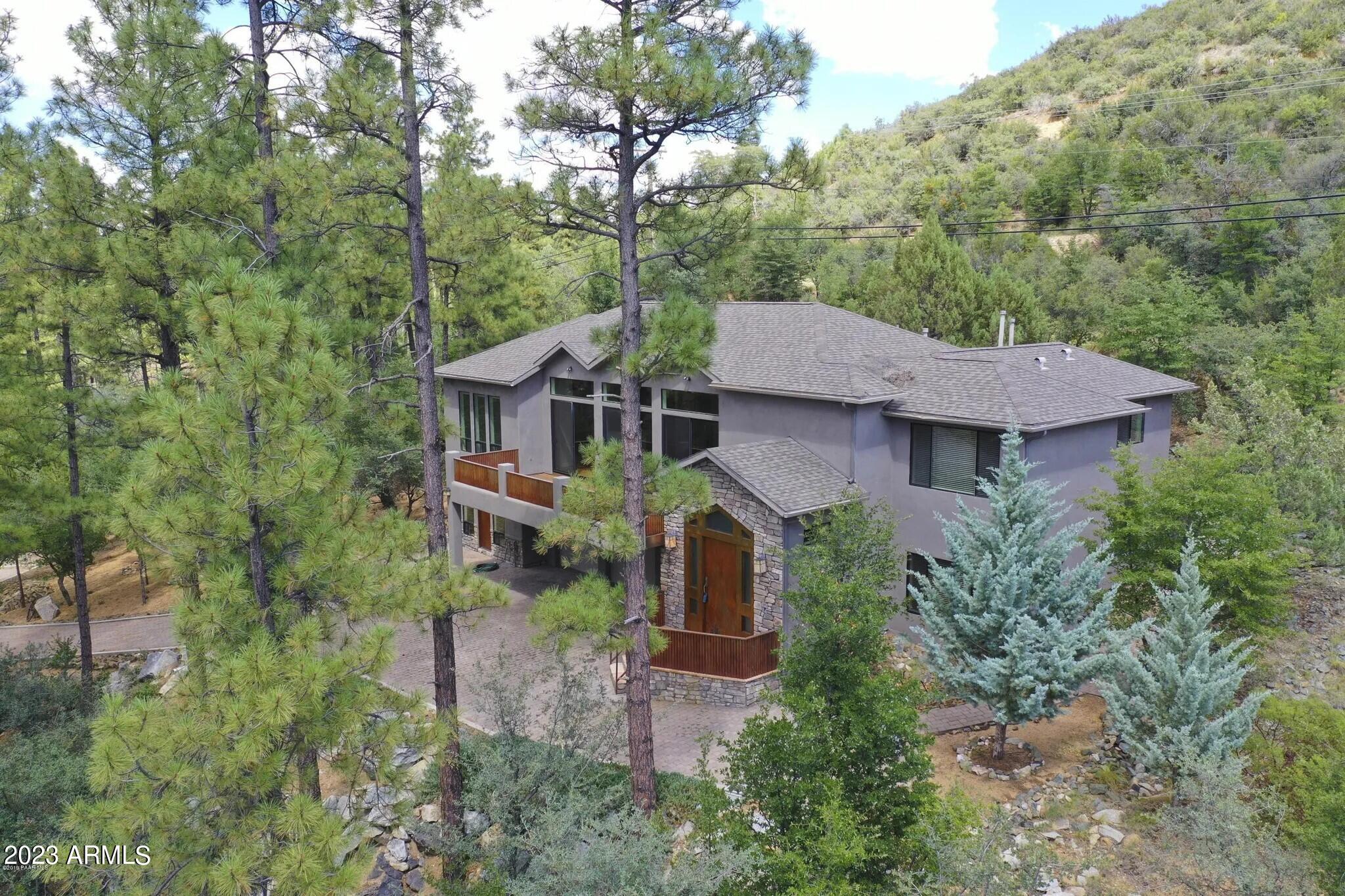 Beautifully nestled among the tall pines of Prescott, this expansive 4,660 SF mountain retreat offers an exceptional blend of privacy, versatility, and convenience--just minutes from historic downtown Prescott. Surrounded by serene mountain vistas and towering pine trees, the home provides a peaceful escape with easy access to nearby hiking trails, abundant wildlife, and the natural beauty Prescott is known for. Deer and other local wildlife are frequent visitors, adding to the tranquil setting. The thoughtfully designed floor plan features 5 bedrooms and 4 bathrooms, including 2 full baths and 2 three-quarter baths, offering outstanding flexibility for multigenerational living, guests, or rental opportunities. On the lower level, two bedrooms are situated on opposite sides of the 3-car .. garage is equipped with built-in storage cabinets, offering ample space for organization and functionality. Located within an easygoing HOA, residents enjoy access to a nearby heated pool and pickleball courts, further elevating the lifestyle this property offers. Currently elegantly furnished, the furnishings may be purchased separately under a separate bill of sale, creating a turnkey opportunity for buyers seeking immediate enjoyment or a ready-to-go investment property. Whether you are looking for a full-time residence, second home, or income-producing retreat, this exceptional Prescott property offers privacy, accessibility, flexibility, and classic mountain charm in an unbeatable setting. The property has also been used as an Airbnb when not owner-occupied and has received wonderful reviews.
Results: 1 Selected: 0