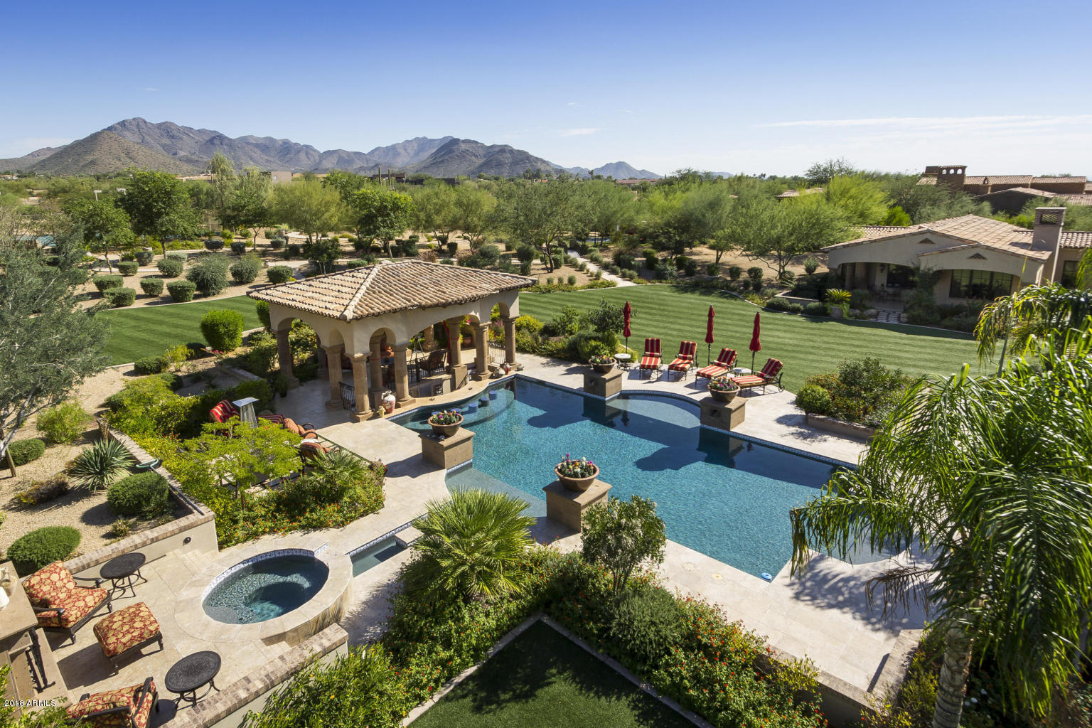 Prestigious gated Prado Estate priced to sell! 20 homesites encompass Prado Estates and this is the largest lot. Complete seclusion & privacy yet, only minutes away from fine dining, shopping & golf. This 10,691 sqft, 8 BD/11.5 BA home (w/elevator) also features a 1,282 SF guest home & 6 car garage. European elegance, romantic setting boasts majestic, post card perfect city & mountain Views. Private gate into the main residence arriving to the perfectly manicured frontage and six car garage. The courtyard entrance is an entertainers heaven with fire pit, water features and sitting area with an envelope of custom pillars. The captivating 3 iron and glass doors
invite you to a home built of the finest finishes. This home truly lives cozy regardless of the square footage. The main level provides master suite, office, secret room, a gourmet kitchen
with two islands, a dining room with the wine room and doors all entering the court yard and garden.  Two view towers and spacious balconies. Resort style grounds provide lush landscaping and abundant amenities including a sparkling pool/spa with swim up bar, fireplace, entertaining Solana, putting green (with bunker) in-ground trampoline, & a full-size tennis/basketball sport court. Breathtaking.