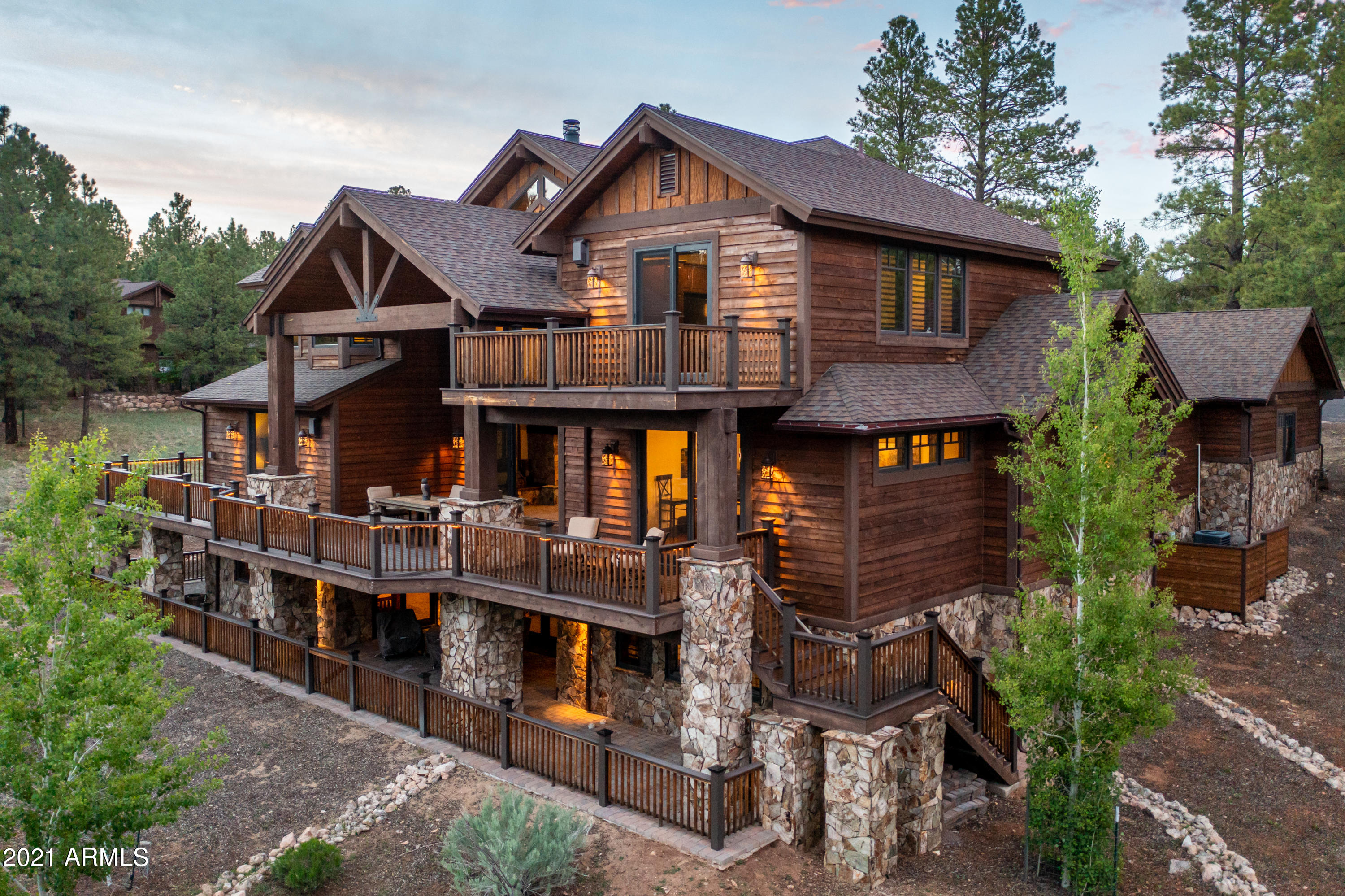 This is the perfect home for that BIG family, at 8,698 sq. ft. and including 7 bedrooms, 7 bathrooms and 2 half baths. The main level of the home features a grand Living Room with vaulted ceilings, tongue and groove ceiling, exposed wood beams and an outstanding floor to ceiling fireplace surrounded by a built-in entertainment center.  Adjacent to the living room is an expansive chef's kitchen with a large island with bar seating, 6 burner range with griddle and a custom metal hood, 2 ovens, full back splash and a massive refrigerator. Just off the kitchen is a walk-in pantry, as well as a little office nook and a formal dining area. 
Take in the breath-taking views of the 12th fairway from the spacious wrap around deck which can be accessed from the living room, dining room and master bedroom. 
The master bedroom is located on the main level and includes a gas fireplace, exposed wood beams, a seating area, and a roomy walk-in closet with a secrete access to the lower level of the home. The master bath includes separate his and hers vanities with stone countertops, a jacuzzi tub, and a separate spacious shower. There are also 2 additional en-suite guest bedrooms on the main level. 
The lower level of the homes massive walk-out basement truly has something for everyone. There are 2 additional family room areas that lead out to the spacious wrap around covered patio, a movie theatre room with stadium seating and surround sound, a card/ game area, tons of storage, and two additional en-suite bedroom one with patio access.
The third level of the home includes a loft area overlooking the lower level that connects 2 en-suite bunk rooms both including 4 built in bunk beds, and a 3rd family room with a fireplace and a private deck. 
Imagine your next family reunion in the towering Ponderosa Pines of Pine Canyon!
*NOTE List Price is for the HOME ONLY on Lot 17. Vacant Lot 18, which Seller expects to bifurcate/split and either hold as an investment or sell separately and is not a part of this listing*