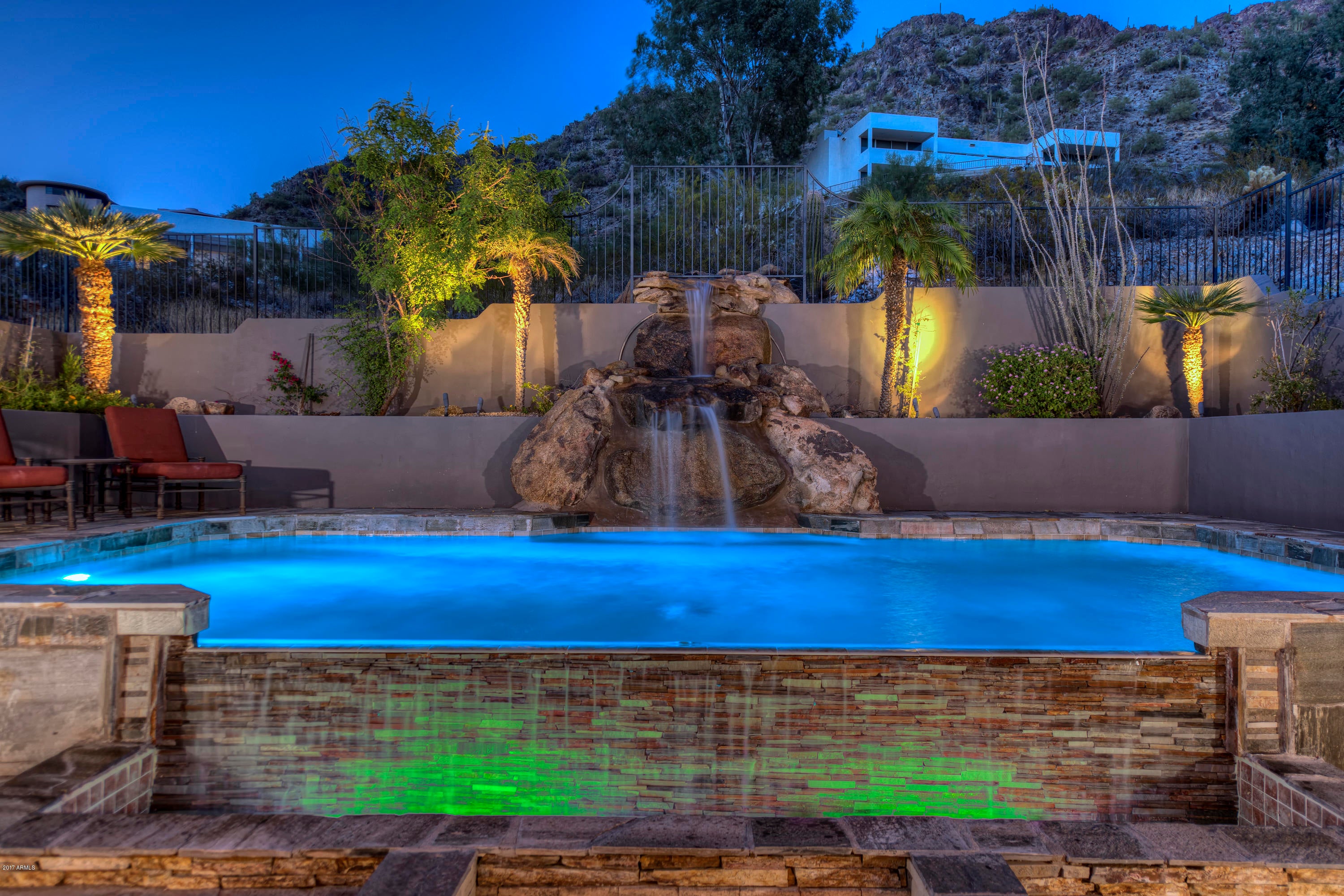 Welcome to this fabulous contemporary home nestled in the hills of the highly coveted Palm Canyon community. Soaring ceilings and abundant oversized windows take advantage of the home's positioning high above the city. Gorgeous mountain and city views abound. Open and spacious, the floor plan creates an ideal setting for entertaining. Exquisite great room features sunken wet bar, 2-way fireplace and adjacent game/wine room, etc., with private patio. Enormous kitchen with tons of rich, modern cabinetry, stunningly huge granite island, high-end appliances and a dumb waiter. Dramatic private dining room overlooks the city. Magnificent oversized office with incredible natural light and beautiful views. Private master retreat features gas fireplace, impressive wood detailing and an expansive bathroom with an oversized jetted tub and steam shower. Stately closet and abundant cabinets for extra storage space. Lavish custom finishes continue through the exterior as well. A grand, stone water feature spills into the spacious, modern, pool with optic lighting. Breathtaking mountain views surround the enormous covered patio with kitchenette and built-in gas barbecue grill. This home is priced well below neighboring comps and Zillow's estimated value of $2,202,102. This is a must see, one of a kind home!