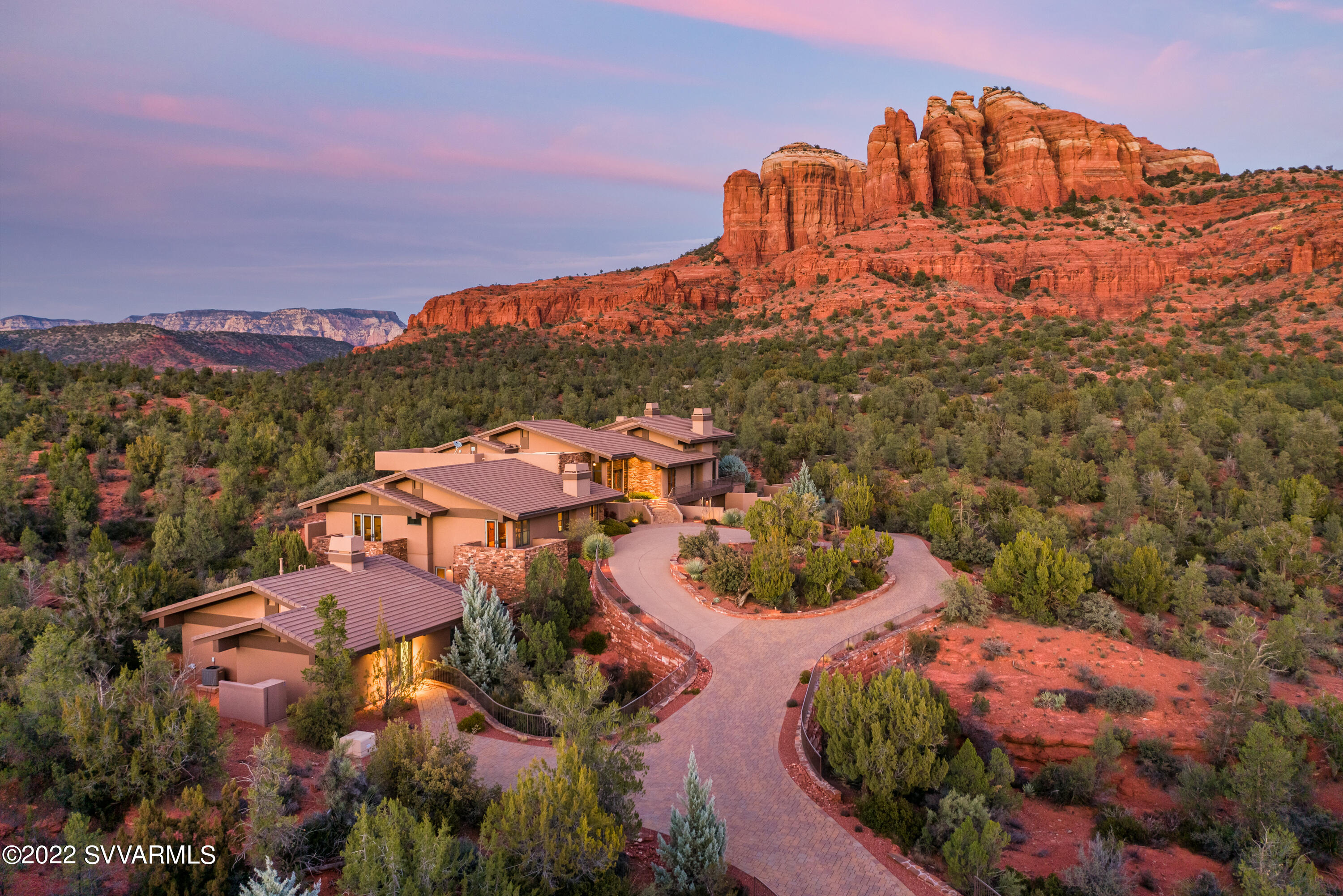 Elite Sedona serenity awaits you as you make this quality estate your home. Experience tremendous intimate views of Cathedral Rock from both indoors and outdoors. This luxurious custom home features high-quality construction with 7,700+ SqFt interior living space in the main house and 1,072 SqFt in the guest home (currently a humidified wood working studio). Health and wellness are in abundance with a heated saltwater pool, jacuzzi hot tub, private workout gym and yoga meditation room. Home entertainment would be ideal in your state-of-the-art soundproof movie theater (currently a recording studio). Enjoy an oversized 4-car garage with room for toys & storage.  Take time to read through the supplemental remarks as this home is special. Remarkable advancements make this home a steal! What the Sellers Love About This Home & Community:
*  Intimate Views & Privacy 
*  Property Borders National Forest At The Base Of Cathedral Rock
*  Quality Construction. Built in 2009 By Bob Pelk (BP Construction) & Architectural Design By Hal Driggs
*  Access To Sedona's Best Hiking Trails (Some Accessed From The Back Yard)
*  Gated Community - With Quiet & Respectful Neighbors
*  Main Living On One Floor: Foyer, Office, Living Room, Gourmet Kitchen, Casual & Formal Dining Rooms, Owner's Bedroom & Ensuite Bathroom
*  Outstanding Exercise Room & Yoga/Pilates/Meditation Room
*  An Abundance Of Natural Wildlife: Deer, Eagles, Hawks, Bobcats, Coyote, Javelina
*  State Of The Art Music Recording Studio Can Be Converted To An Exquisite Home Theater Room. The    
 Soundproof Music Recording Studio Is Supplied With $300,000+ Worth Of Recording Equipment, Which  
 Can Be Purchased Outside Of Escrow On A Separate Bill Of Sale.
*  Home Located At The End Of A Cul-De-Sac With Upgraded Circular Paver Driveway 
*  Whole House Water Filter Plus Reverse Osmosis (RO) In Kitchen
*  Whole House Humidifiers
*  Lot 56 = 2.13 Acres

Exterior Amenities Included:
*  Heated Saltwater Swimming Pool [With An Endless Swim Lane Featuring The Versatility Of Uninterrupted Swimming. Enjoy Gentle Rehab Or Vigorous Cross-Training. Give Kids Some Active Playtime. Pool Includes Automatic Retractable Cover]
*  Hot Tub
*  Expansive Outdoor Covered Dining Patio With Gas Fireplace
*  Built-In Wolfe Barbeque 
*  Fully Fenced Dog Run With Premium Artificial Grass
*  Professional Landscape Design By Desertscapes
*  Spectacular Views From Every Patio & Entertaining Area. 
*  Covered Patios & Full Sunbathing Areas

Guest House/Workshop 1,072 SqFt
*  Guest House [Casita] Converted Into An Exclusive Artisan Guitar-Making Workshop. Builder Recently (2021) Estimated Cost To Convert The Current Workshop Into A Guest House For Living With A Kitchen, Living Room, And Bedroom; Private Driveway & Private Patio For Guests]. See attached quote in Documents in MLS.

Main House 7,705 SqFt
*  Gourmet Kitchen [Wine Refrigerator; Wall-Mounted Pot Filler; Wolf Oven; Sub Zero Refrigerator; Dumb Waiter That Brings Groceries From Garage Into Kitchen; Walk-In Oversized Pantry; ]
*  Living Room [Gas Fireplace, Cathedral Ceiling, Several Entry Doors To Exterior Decks/Patios; Excellent Views]
*  Formal Dining & Casual Dining Rooms
*  Owners Bedroom Suite & Bathroom [Exquisite Views Of Cathedral Rock; Outdoor Shower; Two Walk-In Owner Closets; Radiant Heated Floors In Owners Bathroom; Heated Towel Warmer; Whirlpool Bathtub; Steam Shower]
*  Yoga/Pilates/Meditation Room Located In Owners Suite
*  Office
*  Family Room/Den [Mini Refrigerator; Microwave; Automated Blinds]
*  Four (4) Ensuite Guest Bedrooms [Each Guest Suite Offers Balcony or Patio]
*  Fitness Room [Gym Equipment Can Be Purchased Outside Escrow On Separate Bill Of Sale]
*  Bathroom [Located Near Fitness Room]
*  Recording Studio
*  Oversized 4-Car Garage [Ample Room For Off Road Vehicle(s); Half Bathroom For Workers With Outside Entrance; Enormous Storage Area; Wine Refrigerator; Epoxy Floors]
*  Laundry Room [Dog Washing Station; Laundry Shaft From 1st Floor]
*  Mechanical Room

Superior Finishes, Appointments, And Features Included:
*  Surround Sound
*  Whole House Humidifier
*  Whole House Water Filtration System
*  3 Gas Fireplaces
*  Venetian Plastered Walls [You Can Paint Over The Glass-Smooth Texture]
*  Fire Suppression/Sprinkler System [With Alarm]
*  Full Security System [With Alarm & Video]
*  Crestron Smart Home Features
*  Elevator Shaft Installed To Reach All Four Levels - Elevator Not Included]
* Crawl Space Has Concrete Floors (Rare In Sedona)

Miscellaneous
*  Furniture (Designed By Professional Designer, Stephanie Larsen) Is Available Outside Escrow On Separate Bill Of Sale; Best Negotiated During Due Diligence Period]
*  Gated Community In Cathedral Rock Ranch With Upscale Luxury Custom Homes
*  Propane Tank [1,000 Gallons Owned]
*  Steps Away From The Outdoor Oasis Is Access To The Baldwin Trailhead That Leads You To Hiking Paths Throughout Cathedral Rock, Crusader Rock, And Table Mesa
*  Seven (7) HVAC Zones
*  Buyer Will Be Offered First Right Of Refusal To Purchase The Adjoining Lot 57. [Parcel: 408-30-084 on 1.93 Acres)]
*  Recording Studio Description Available Upon Request
