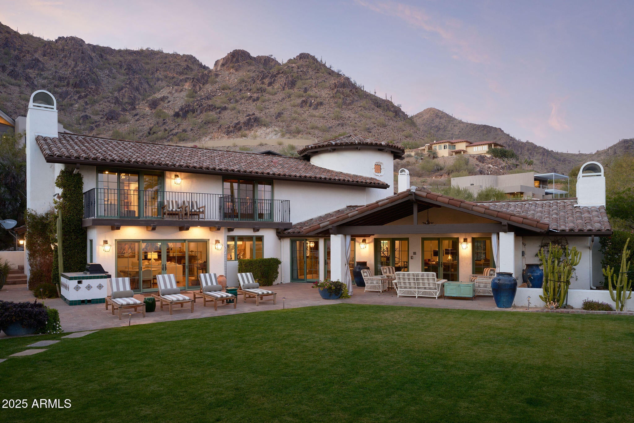 An exceptional example of Modern Spanish architecture and interior design make this a
must-see lock and leave home in beautiful Clearwater Hills. On a flat 35,000 square foot
lot; covered patios, lush grass, and native plants make for a low maintenance landscape
with plenty of room for entertaining and enjoying the unstoppable views of Camelback
Mountain. Totally rebuilt and taken to the studs in 2022, the interiors are spacious, and
light filled with a gourmet kitchen opening to a family room with a fireplace and a fabulous
bar. There is a stunning library/den, powder room, gorgeous dining room, and a huge great room with fireplace on the main floor. Upstairs you will find a serene primary suite with an attached office that could be converted to a bedroom. There are two guest rooms that share a jack and jill bathroom as well as a second master suite. This home is all about comfortable, elegant living whether it is your primary residence or a second home you can't wait to visit.