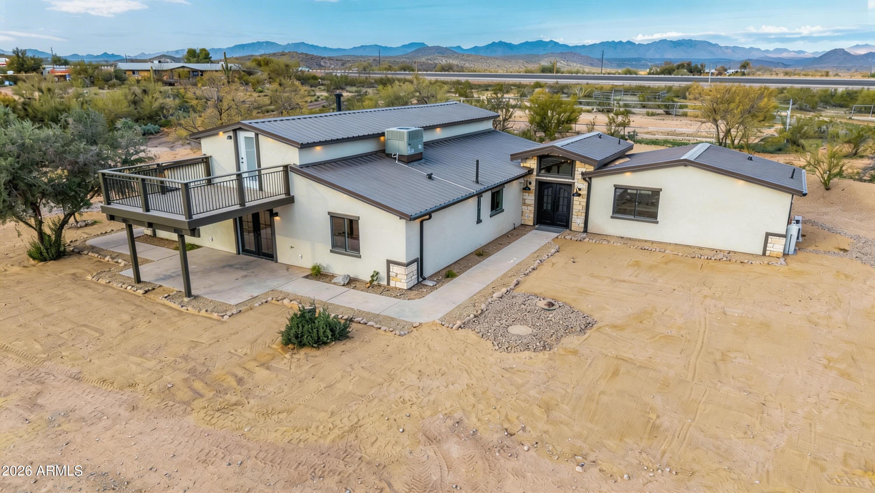 SIMPLY ONE OF THE BEST VALUES CURRENTLY AVAILABLE IN WICKENBURG. Located within Wickenburg city limits, this energy efficient 4 bedroom, 3.5 bathroom, 4 car garage, 3,120 sq ft custom home sits on nearly 5 LEVEL acres with Horse privileges and detached 900 Sq ft steel workshop/garage. Beautiful 2025 Full Renovation from the ground up situated privately at the rear of the property. All New upgrades include: Chef's Kitchen with built-in high end appliances, all tile main level, new plumbing throughout, all new electrical, full OSB exterior, synthetic stucco, spray foam insulation, Steel Roof, HVAC and ducting, Windows and Doors, and a new walkout deck with stunning views of Vulture Peak! Enjoy the remodeled pebble tec pool. 2 mi. from Rancho Rio Arena, minutes to Golf, downtown and shopping. Ample RV and trailer parking, room for roping arena. Rare Opportunity near Downtown.