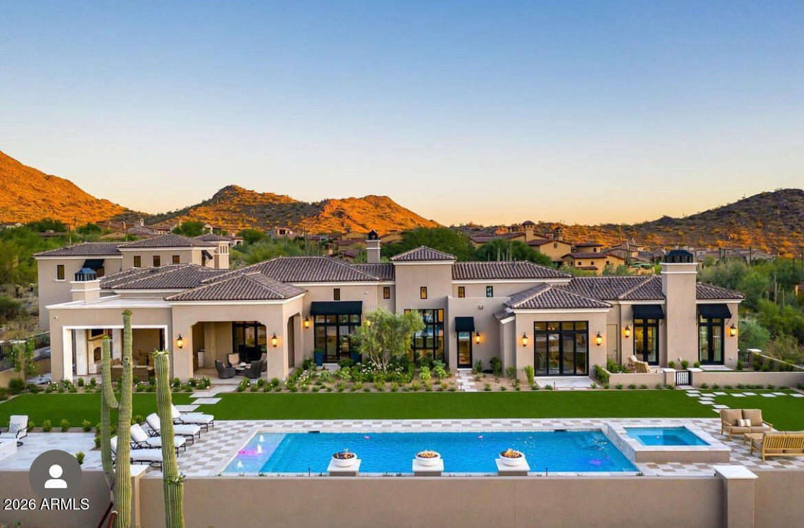 **IMMEDIATE GOLF MEMBERSHIP AVAILABLE** Experience the pinnacle of desert luxury in this 6100 sq. ft. estate set on 2 private acres within the prestigious, 24 hour guard-gated community of Silverleaf. This 4-bedroom + den, 6-bathroom residence combines exquisite finishes with timeless design, creating a home that is both elegant & livable. All major living areas located on the main level. Expansive windows capture stunning mountain and city light views, filling the home with natural light. The gourmet kitchen, featuring all Wolf appliances, custom cabinetry, & an oversized island with 2 Bosch dishwashers, opens seamlessly to grand living & dining spaces, ideal for both everyday living & entertaining. The primary retreat is a true sanctuary, complete with dual his and hers closets, spa-lik bath with steam shower, washer/dryer, & gorgeous soaking tub. Each secondary bedroom includes en-suite baths with refined designer touches. Designed for resort-style living, the backyard showcases a sparkling pool & spa, gas fire pots, cozy fire pit, & 2 covered patios with misting fans for year-round enjoyment. Whether hosting guests or savoring quiet evenings, the outdoor space perfectly  compliments the breathtaking surrounding views. Nestled within the private Silverleaf community, this Silverleaf estate offers an unmatched lifestyle of sophistication, comfort, & serenity. Home has unused land to add a guest home.