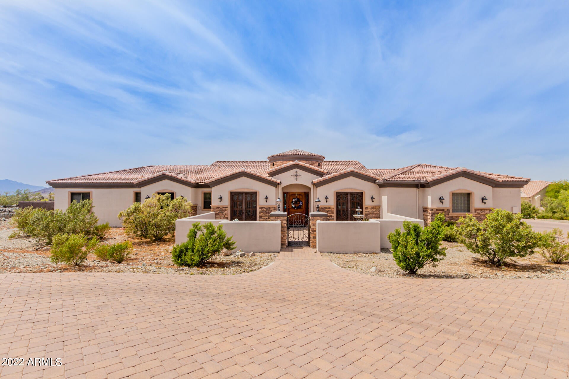 Impressive Custom Home with Expansive Outdoor Living and Entertaining.  Located on the Phoenix/Laveen Border, 20 minutes to Downtown/Sky Harbor And 5 minutes to the loop 202.  Part of a community that has a private Runway!  6 Bedrooms, 4.5 baths, Formal Dinning, Office, 2 Living Rooms, Basement & Nursery/Craft/Exercise Room off Master. Built of ICF block, finished with synthetic stucco and sprayed foam attic. Exterior painted in 2020.  4 car wide, extra deep insulated and AC cooled garage w/ 3 doors for plenty of storage!  Instant hot water, RO filtration,  split zone AC.  1000 Sq Ft of covered patio with misting & sound system overlooks the self cleaning salt water pool with rock slide, grotto & Spa.  Solar & Gas heat for pool and spa!  Covered ramada featuring swim up bar, kitchen & BBQ. Gourmet kitchen boasts GE Profile stainless steel appliances.  Oversized breakfast bar is an entertainers dream.  Granite counters, custom exhaust hood and special design for a full sized fridge that still gives the counter depth appearance.  Master bedroom has a walk in shower & Jetted tub.  Double sinks & make up vanity.  Custom closet with drawers.  Entire driveway and circular pull around finished with pavers.  RV parking. For the Aviation enthusiast, the owner has run septic, 200 Amp electrical and water lines to the proposed site of the Hangar.  You have the ability to land on the paved runway and taxi directly to your lot and future hangar.  Make this your home today!