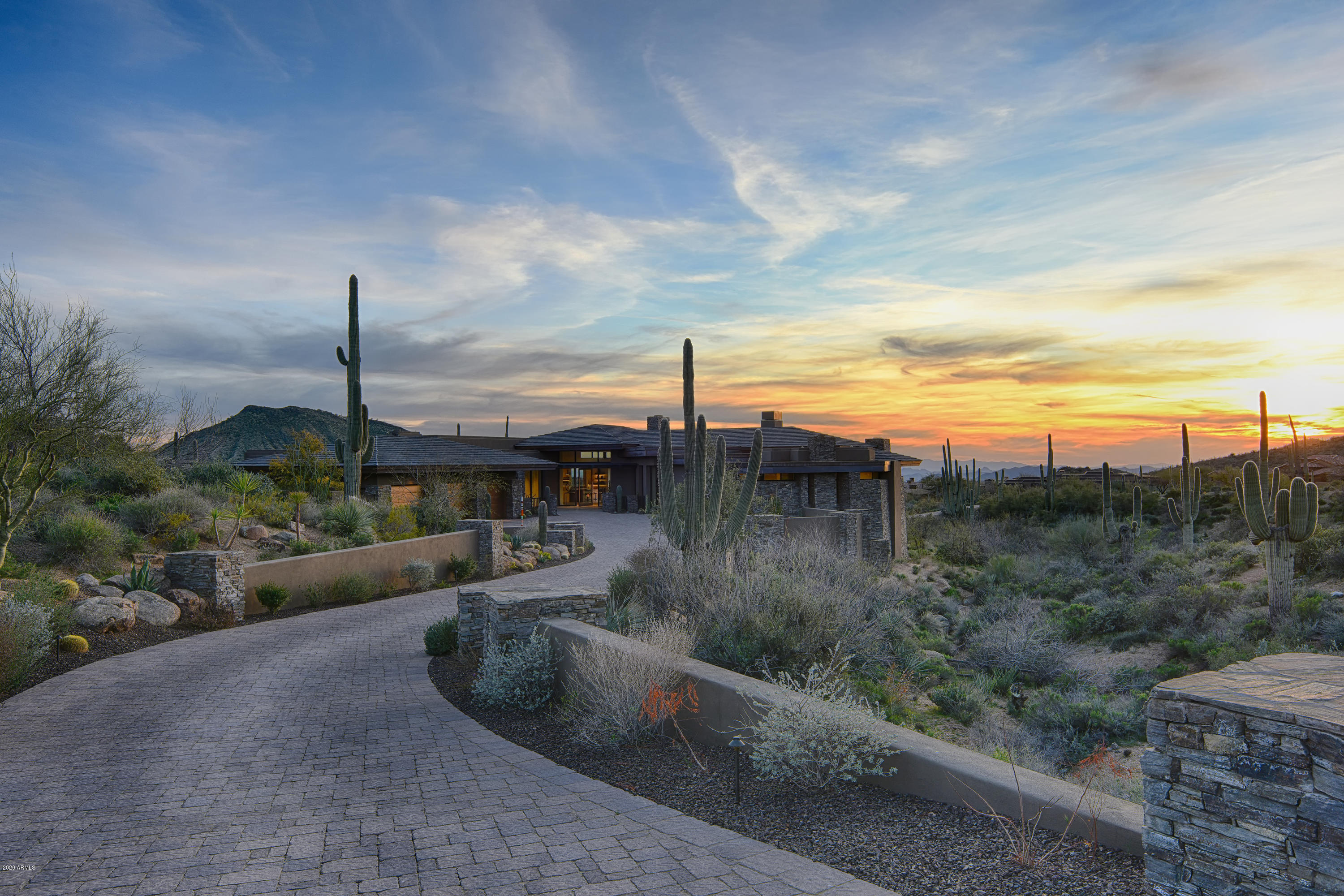 Extraordinary contemporary masterpiece located  in the village of Saguaro Forest.    This 2018 Lee Hutchison designed home built by Dick Lloyd is situated on over two acres with panoramic views in every direction.   The estate property was designed with a modern flow that offers open free-flowing single level living between inside and out.  With the touch of a button your walls of glass open onto an expansive veranda accessing the sparkling pool and outdoor living areas.  The state of art chefs kitchen is easy flowing and offers a central gathering point open to all of the living areas.   Not to be missed is the opulent owners retreat with spa bath and steam shower. Built-in dual closets offer easy storage and washer dryer combo.   For car enthusiasts there is even a 5 car garage! Game room and workout areas are located on the lower level with both stair and elevator access.