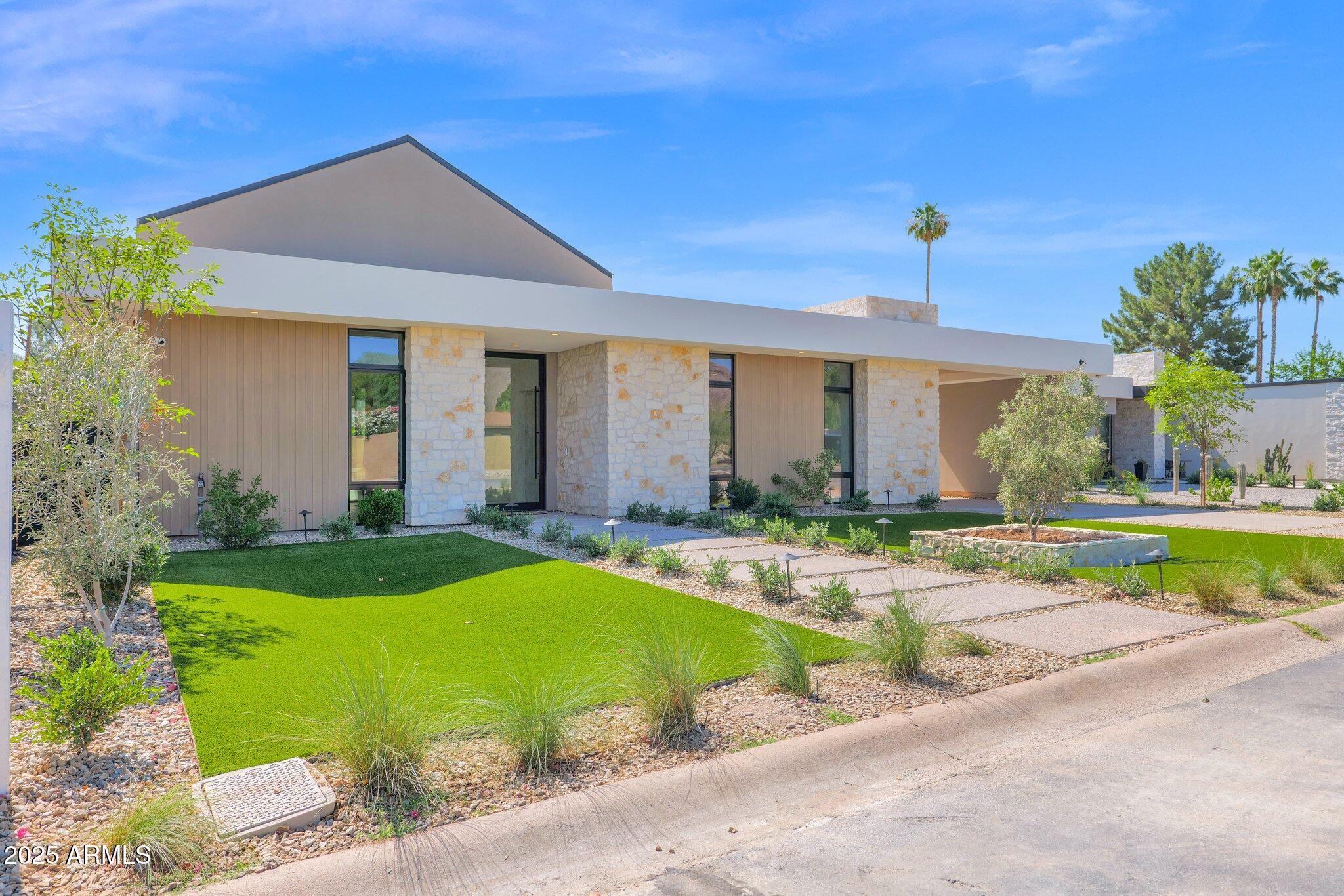 Located in the desirable Arcadia area  of Phoenix, this NEW BUILD will offer unparalleled luxury & comfort across its expansive layout. Upon entering, you are led seamlessly into the grand living spaces filled with natural light from floor to ceiling glass windows, sliding glass walls & vaulted T&G ceilings with skylights. The gourmet kitchen is a chef's delight. Featuring Wolf/Subzero appliances, custom cabinetry, a large back kitchen and a 15' island overlooking the backyard oasis. The bar area features stackable windows for indoor/outdoor entertainment. A custom floor to ceiling temp controlled wine display showcases your collection, while defining the dining area and the living room with a stacked stone fireplace. The primary suite is a true retreat, featuring a vaulted wood T+G ceiling, stacked stone fireplace, and direct access to the pool and spa. The en-suite is complete with a soaking tub, dual vanities, & a large walk-in shower for two. Each additional bedroom includes its own ensuite. The outdoor area is an oasis unto itself, with a sparkling pool & soothing spa where you can relax & unwind. The expansive patio & landscaped grounds provide ample space for outdoor dining, lounging, & enjoying the Arizona indoor outdoor lifestyle year round.

Additional features of this exceptional home include:
High ceilings & an abundant of natural light throughout. A spacious flex room that can be used for a 5th ensuite, office, or pool entertainment room. State of the art technology & smart home capabilities. Three car garage with ample storage space. Located in the Arcadia area, this home is in Hopi Elementary boundaries and a 3 minute drive to Phoenix Country Day School. Offers walkability to some of the areas upscale dining & entertainment, while also being in between Biltmore Fashion Park and Old Town Scottsdale. Enjoy the nearby hiking trails of Camelback Mountain or some of the finest golf courses. The Arcadia lifestyle awaits!