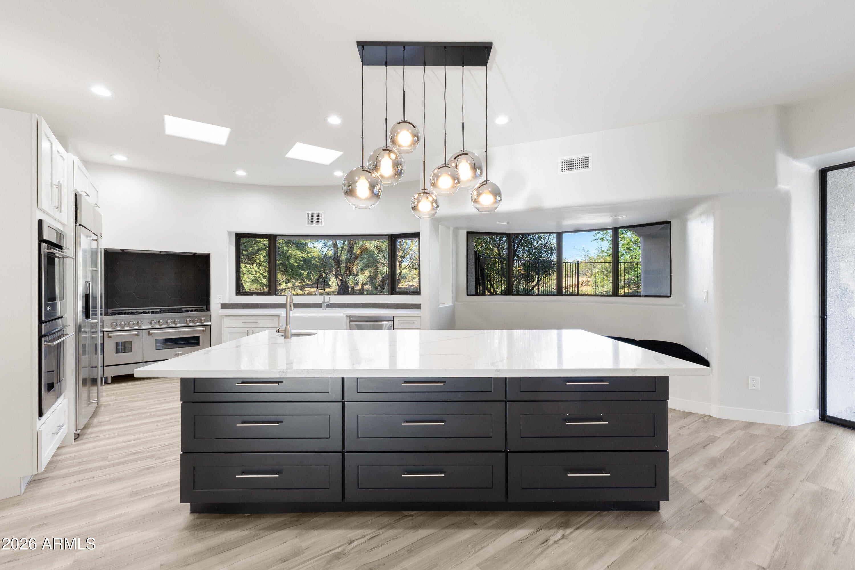 Nestled on a private, interior acre-plus lot within the prestigious guard-gated community of Sincuidados, this beautifully remodeled modern residence offers refined living surrounded by pristine Sonoran Desert beauty. Upon entry, you're welcomed by an abundance of natural light streaming through floor-to-ceiling sliding glass doors in the spacious living room and a wall of windows in the formal dining area, seamlessly blending indoor and outdoor living. The thoughtfully designed split-level floor plan features four ensuite bedrooms, including an oversized guest suite with its own private paver-stone courtyard and direct access to a single-bay garage, ideal for guests or multi-generational living. The luxurious primary suite is a true sanctuary, complete with a gas fireplace, private bonus room/den with separate entrance, and direct access to a cozy courtyard featuring a gas fireplace. The spa-inspired primary bath showcases designer lighting and finishes, a generous walk-in closet, and the convenience of a full-sized washer and dryer. The light-filled chef's kitchen has been remodeled to perfection, centered around an expansive quartz island with vegetable sink and beverage drawers. A large picture window frames serene desert views, while premium features include a ZLine gas range, built-in stainless-steel appliances, walk-in pantry, banquette seating, and a charming gas fireplace. Outdoor living is equally exceptional. A deep covered patio off the kitchen is equipped with a built-in BBQ, extensive counter space, and ample room to create a custom outdoor kitchen. The resort-style backyard offers a sparkling pool, two-way gas fireplace, and two lush grass areas perfect for pets, play, or a putting green. Seller has invested almost $50,000 in repairs to property. Sincuidados is a low-density, guard-gated community spanning nearly 600 acres of private, protected Sonoran Desert. Residents enjoy a 100-acre nature preserve encompassing most of Lone Mountain, complete with private hiking trails. Community amenities include tennis and pickleball courts, basketball, a clubhouse, and private streets ideal for walking, jogging, and biking. Directly across from the entrance, residents have access to the 25,000-acre Scottsdale Desert Preserve one of the largest urban preserves in the country offering hiking, horseback riding, and mountain biking. A vibrant social committee hosts regular community events throughout the year. Conveniently located near North Scottsdale, Grayhawk, Kierland, Cave Creek, and Carefree, this home offers easy access to world-class golf, dining, shopping, and outdoor recreation.
