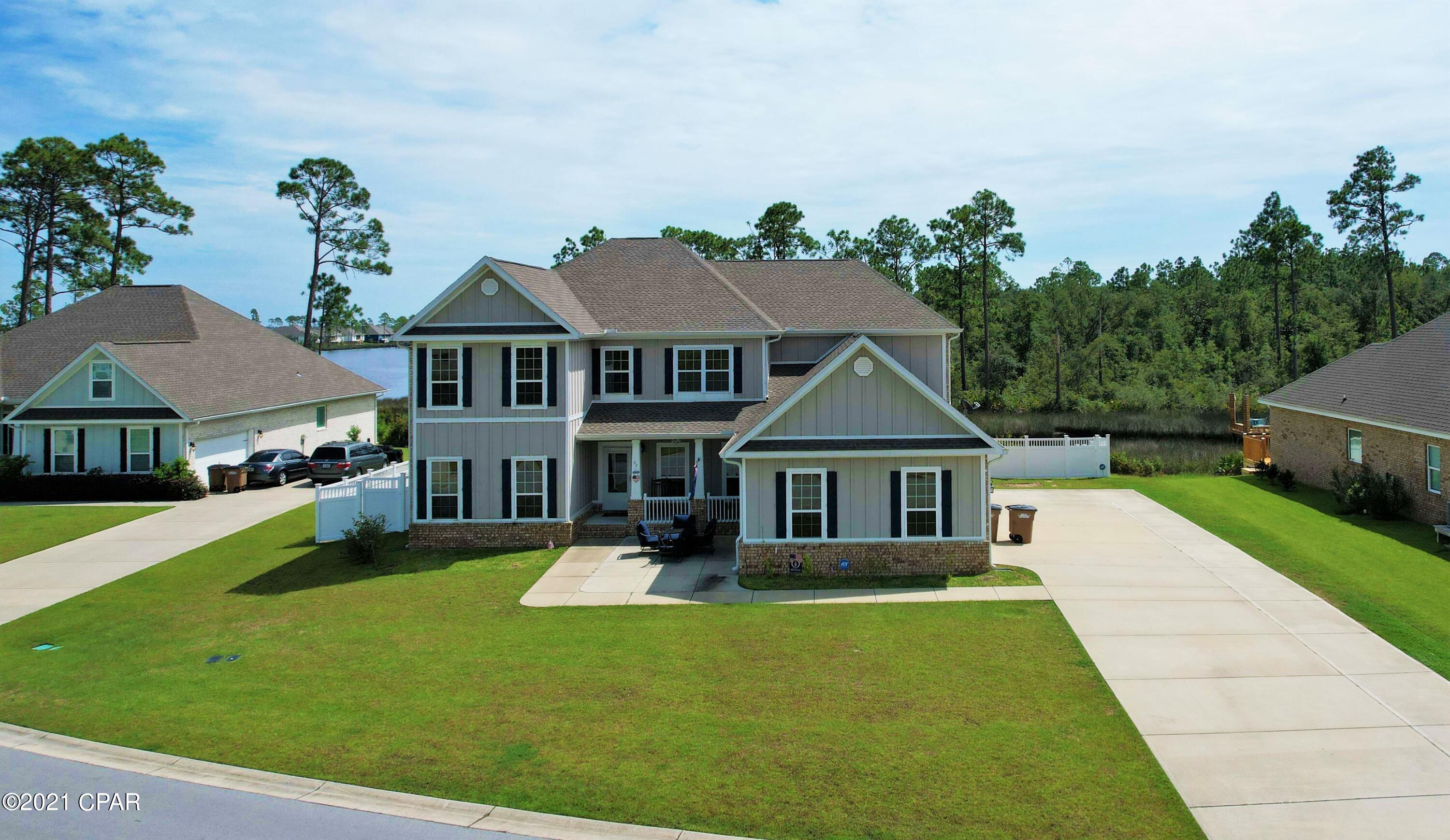 Waterfront home in Fanning Bayou with dock and bay/gulf access!  This 5BR/4BA home is built with family in mind thanks to all the spacious rooms and floor plan.  The Master Suite is on the first floor while the additional bedrooms are on the second floor.  There is a bonus room on the first level next to a full bath that could also be used as a Mother-in-Law suite/guest room.  Another bonus room on the second floor would work great as a home office/climate-controlled storage, etc...  The view of the Bayou is phenomenal and the seller say the dock can accommodate approx a 21'+ boat!  Features include hardwood floors, 9' ceilings and crown molding, stainless steel appliances, granite counters, enormous screened porch and a 3 (three) car garage!  Fanning Bayou amenities include a central mailbox system, community pool, covered pavilion and picnic area with barbecue grills, and a playground, all fantastic for fostering a real sense of community!  You're in a very quiet part of Bay County, yet you're convenient to schools, shopping, dining and so much more!  All info is approx and must be verified by Buyers if important.