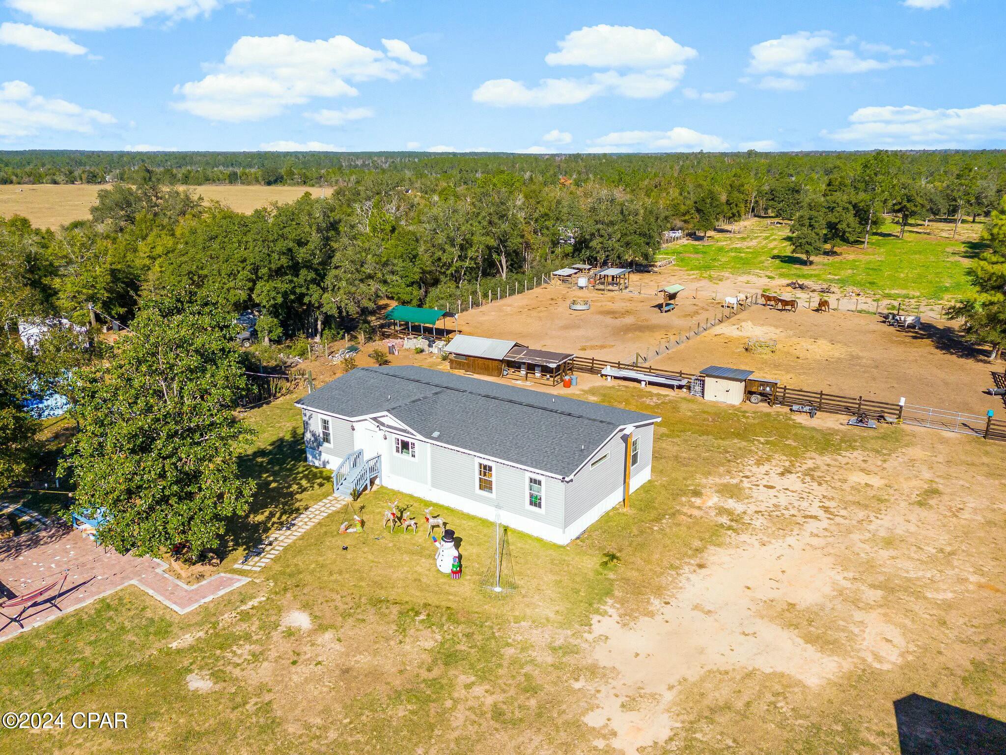 3 BD 2 BA, nice clean, almost new house, it is  sitting  on 5 acres, what a  great oportunity  to own a small farm in a  private area, with not deed restriction, enjoy the country living yet very close to the sugar white sand of Panama City Beach, the best of both worlds.  The entire property is fenced with 6-inch diameter posts every 8 feet, all of which are fixed with cement, and 8 barbed wire fences. 
1 large chicken coop built with treated wood and a metal roof. 
1 10x10 dog kennel. 
1 paved patio. 
1 bathroom in the patio with toilet and shower. 
1 12x12 horse stall. 
1 24x24 shed with milking station paved with pavers. 
1 20x16 house. Electrical and plumbing done (easy to turn into a studio). 
1 round pen for working horses. 
1 16x30 portable building. 
7 pig pens. 
3 pasture divisions for raising animals and facilitating management. 
1 6x8 well house. 
Very good and clean water, tested and suitable for human consumption, property is  dry not in a  flood area.
 The tractor and the farm animals are not included  in the sale price, but can be negotiated.
All measures are approximate and should be verified by the​​‌​​​​‌​‌​​​​‌​​‌​​​​‌‌ buyer.