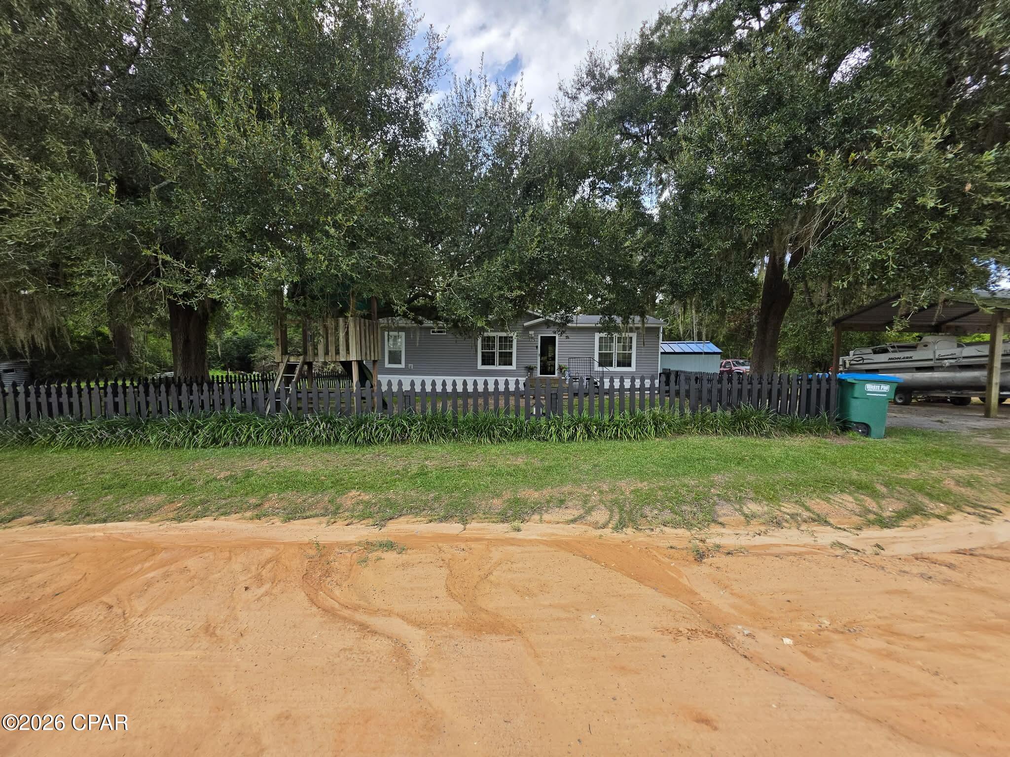 Discover Your Private Country Retreat on 4 Acres in Cottondale, Florida!

Escape the hustle and bustle and embrace the tranquility of country living with this expansive 3 bedroom,  2 bathroom double wide home, perfectly situated on four sprawling acres. This property is a rare find, offering a fantastic combination of comfortable indoor living and incredible outdoor versatility.

Step Inside: The heart of this home is the spacious, open-concept living area, which flows seamlessly into a stunning kitchen featuring a large center island--perfect for meal prep, casual dining, or gathering with friends and family. The split floor plan offers privacy, with a generous primary suite separated from the additional guest bedrooms.

Outdoor Oasis & Workshop Wonderland: This property is a dream come true for hobbyists, car enthusiasts, or anyone needing ample storage. A detached pole barn provides excellent covered parking for boats, or multiple vehicles, while several additional outbuildings offer endless possibilities for workshops, storage, or a home-based businesses.

Enjoy the Florida sunshine in your own backyard! Cool off in the refreshing above-ground pool, host summer barbecues on the covered back porch, and admire the classic charm of the picket fence that frames the front yard.

Nature at Your Doorstep:  Whether you're looking to farm, garden, or simply enjoy the peace and quiet of nature, this acreage provides the space to make it happen.

This is more than just a house; it's a lifestyle. Don't miss your chance to own this slice of Florida paradise. Schedule your private showing today!