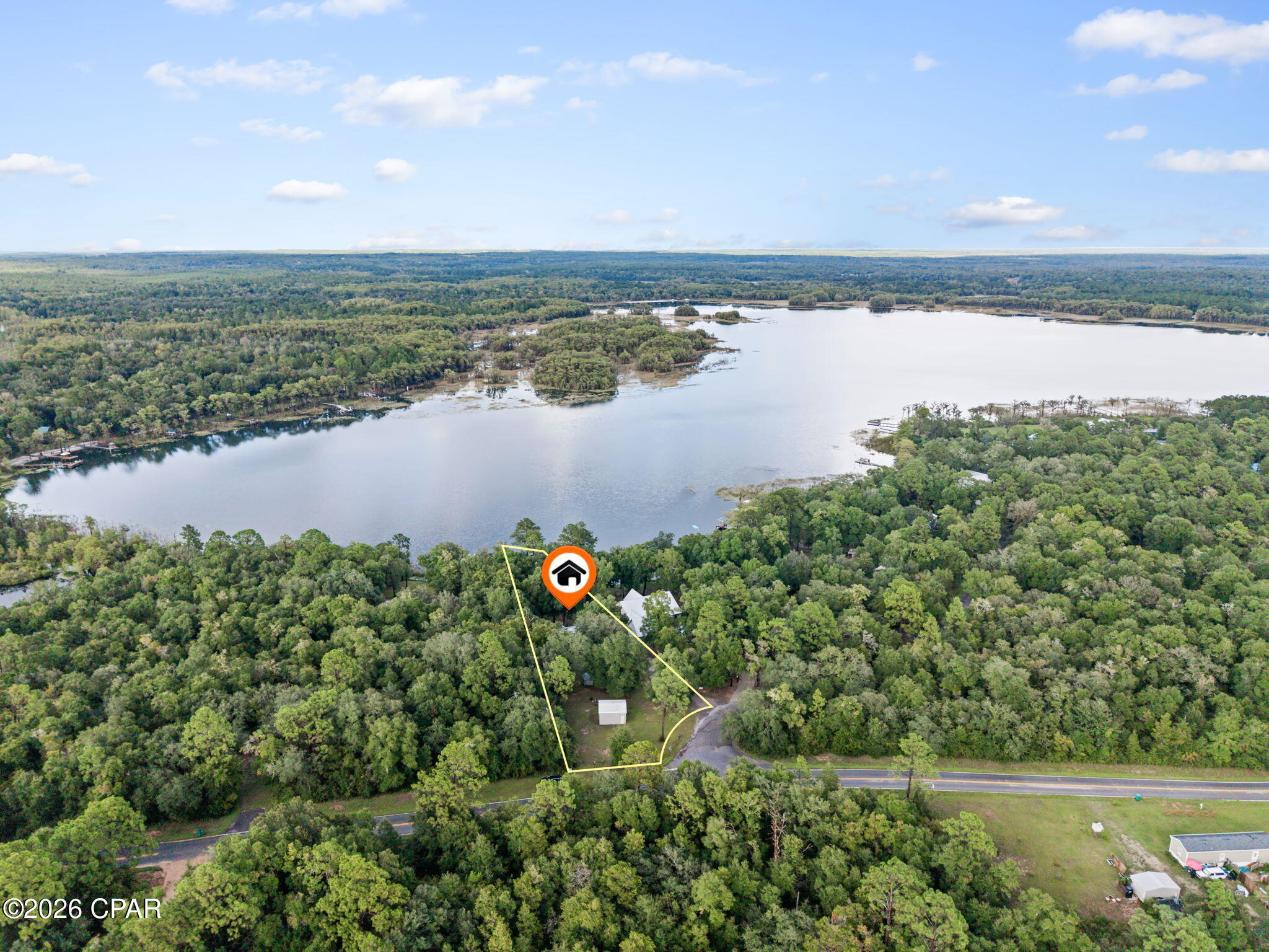 Lakefront living is calling! Situated on over an acre along desirable Lucas Lake, this 2-bedroom, 2-bath waterfront home offers a peaceful setting to enjoy everything Northwest Florida lake life has to offer. Inside, the open-concept layout creates an inviting flow between the main living areas, while the split-bedroom floor plan provides added privacy. One bedroom features its own ensuite bath, making the layout comfortable and functional. Step outside and spend your days swimming, fishing from the dock, taking the boat out on the water, or simply relaxing on the screened porch while taking in the beautiful lake views. With over an acre, there's plenty of room to enjoy the outdoors and the quiet surroundings. Conveniently located betwen Chipley, I-10, Lynn Haven, Panama City, Panama City Beach, Northwest Florida Beaches International Airport, and several recreational springs. Whether you're looking for a full-time residence or a waterfront getaway, this Lucas Lake property is ready for you to come enjoy the view and make it your own!