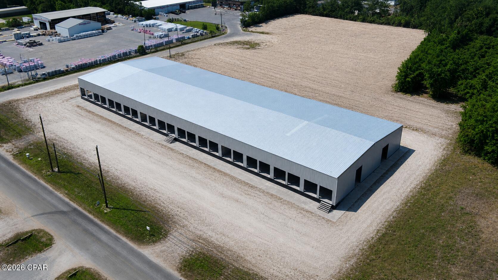 This 30,000± SF newly constructed warehouse is purpose-built for efficient distribution and long-term performance. The facility features 28 dock-high doors, three additional dock positions on a uniform loading platform, and 10 grade-level doors - providing exceptional flexibility for a wide range of logistics and industrial operations.

Situated on a site with up to 4.0± acres of additional land available for outside storage or truck parking, the property benefits from Bay County's flexible Industrial-2 zoning, allowing for scalable operations and future expansion. The building is designed for multi-tenant or single-user functionality, with three divisible bays, each equipped with new restrooms and infrastructure to support further buildout as needed.

Clear heights of 18' at the eaves and 21' at the ridge, combined with reinforced concrete slabs, support efficient racking, storage, and heavy use. The corner lot configuration provides excellent truck ingress and egress, enhancing circulation and operational flow.

Strategically located in central Bay County, the property offers immediate access to Highway 231 and Highway 98, enabling efficient regional connectivity. Estimated completion: July 2026.