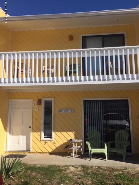 This townhouse style condo is located across the street from the beach. There is a community pool. Here you can park right at your front door and the back yard has plenty of grass for the kids & or pets. It is furnished & rental ready. The roof was replaced in 2013. Seller currently pays the $1253 for the wind coverage and $779 for homeowners.