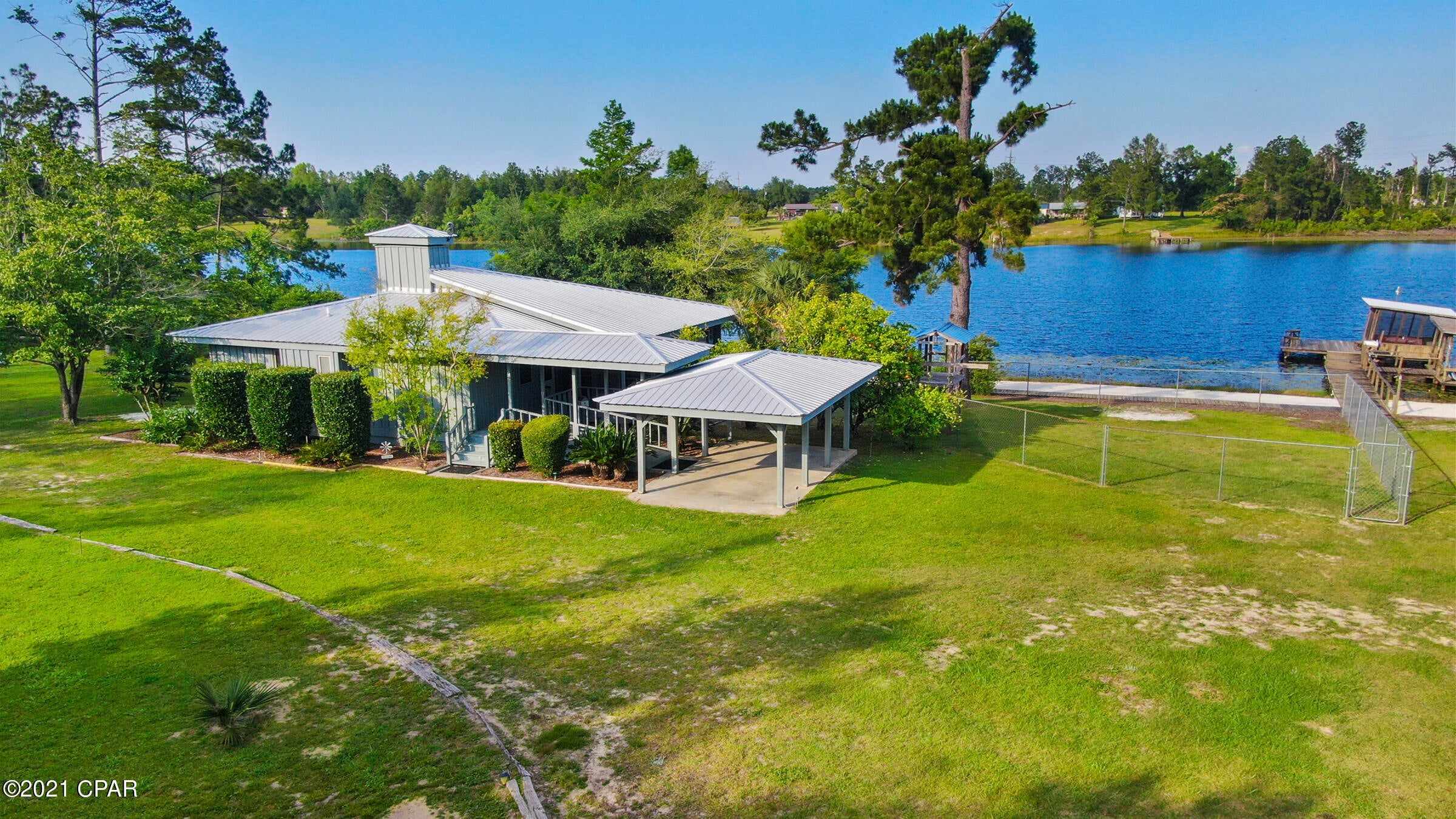 The UN-BEACH retreat! Look no further for your primary residence or weekend getaway than this cottage in the woods on a semi private lake. 

Masterfully crafted and designed by the original architect/owner, this home offers comfort, privacy and unparalleled amenities less than an hour from Panama City, FL or Dothan, AL. This custom-built cabin with 2 bedrooms/2baths is mostly cypress construction with hardwood floors, cypress siding, 9 ft ceilings and updated kitchen with granite countertops. Boasting a 12 ft. wide screened in porch that wraps around 2 sides of the house, (400 sq.ft. total), which is perfect for enjoying the view and breezes off the lake and catching that perfect afternoon nap. Situated on 2.5 acres of land with 312 ft on the private, spring fed lake, (Lake Highlands), fishing for trophy bass on this "electric motors only" lake or just relax on your 80 ft pier with a 12x12 covered boat house with a fish cleaning station. 

Fruit trees are abounding, including 4 orange and 1 lemon tree, pomegranate and persimmon, blueberries and two varieties of grape vines. The newer metal roof and sprinkler system reduces your outside maintenance and the 11x16 shed has enough space for your golf cart and gardening supplies. 

Your own private paradise awaits you! You owe it to yourself to look at this beauty, it will not last long!