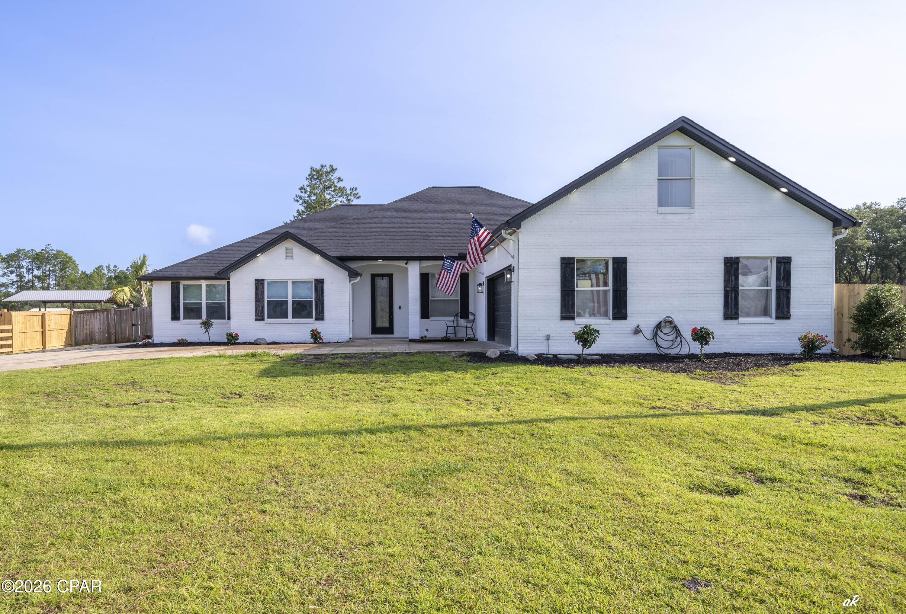 221 White Oaks Boulevard, 2 parcels, split for two separate homes, workshop and home, many possibilities! Enjoy the space and freedom that draws so many people to Southport while still being just minutes from Lynn Haven, Panama City, and Panama City Beach. Situated on 3 acres across two parcels with frontage on both White Oaks Boulevard and Skunk Valley Road, this property offers flexibility that's hard to find. The approximately 4,000-square-foot home features 5 bedrooms, 2 bathrooms, multiple living areas, a formal dining room, an eat-in kitchen, a bonus room, and recent updates including flooring, appliances, and other interior improvements. Highlight- possible to split and make two separate properties, one on White Oak and one on Skunk Valley with two separate dwellings! Step outside and you'll quickly see what makes this property special. The backyard is set up for enjoying the outdoors with an in-ground pool, hot tub, outdoor kitchen, cabana, fire pit, basketball court, outdoor shower, pool bath, and a playhouse. Need room for projects, toys, or a business? The approximately 4,000-square-foot shop includes a vehicle lift and offers plenty of space for equipment, storage, hobbies, or a home-based business. The property also includes two separate one-bedroom apartments, providing excellent rental or guest accommodations, plus an RV site with full hookups for visitors or additional income potential. A private gym adds even more versatility. With no HOA and room to spread out, this is the kind of property that's becoming increasingly difficult to find. Whether you're looking for space for your family, a place to run a business from home, room for all your hobbies, or a property with built-in income opportunities, this one checks a lot of boxes. If you've been looking for country living without feeling isolated, you'll appreciate the location. Enjoy the peace and privacy of Southport while staying just a short drive from Lynn Haven, Panama City, boat ramps, shopping, restaurants, schools, and the beaches.Properties with this much land, this many improvements, and this level of versatility rarely come available. Schedule your private showing today.