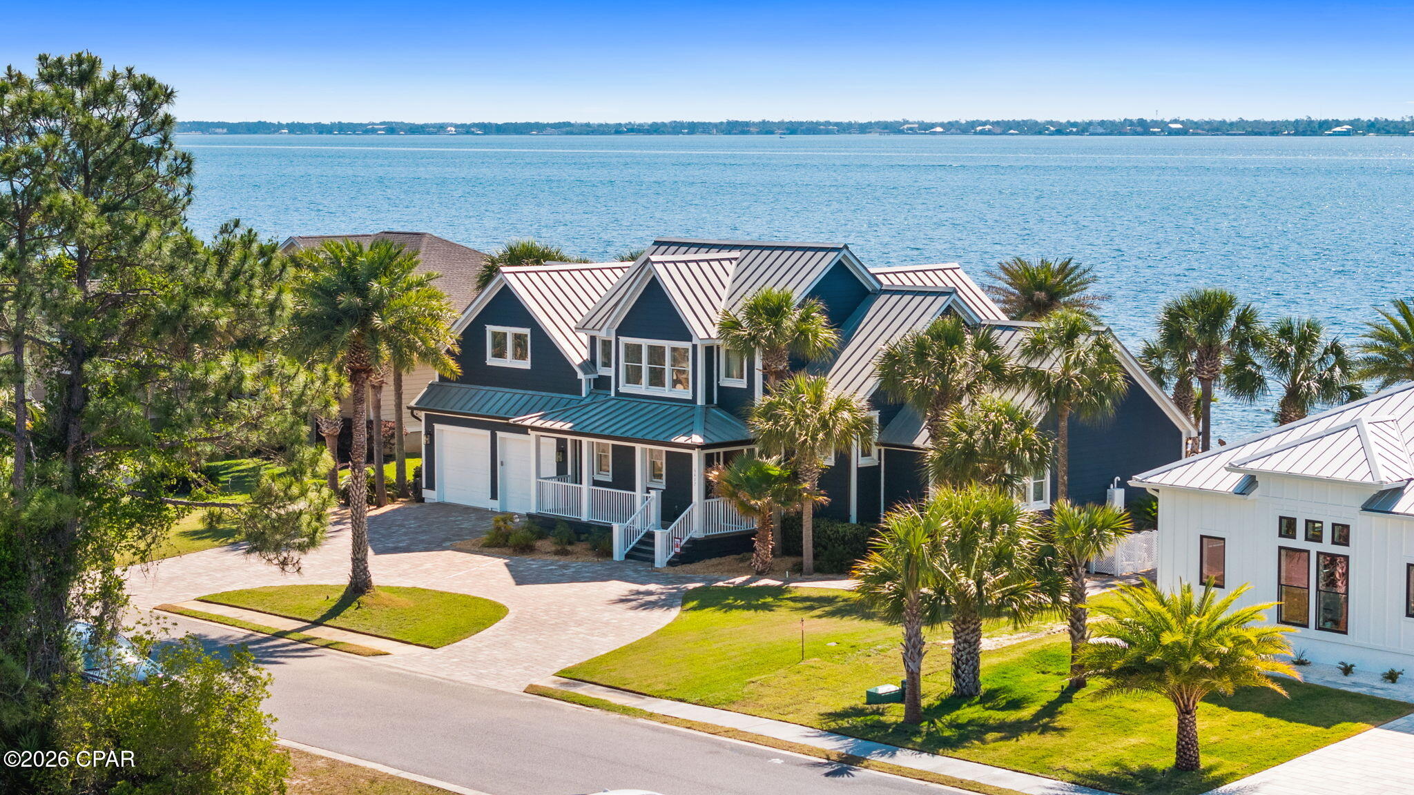Pre appraised and ready to go, this home is priced to sell. Motivated sellers are ready to make a move bring your strongest offer.

Coastal luxury meets everyday comfort in this exceptional bayfront residence offering 4 bedrooms, 3 full baths, and 1 half bath, thoughtfully designed to showcase both style and waterfront living. Rich pine hardwood floors, soaring vaulted ceilings, and an open, airy floor plan create a warm yet elevated atmosphere. An upstairs balcony overlooks the main living space, adding architectural charm and an impressive sense of scale.

The recently renovated chef's kitchen blends modern finishes with timeless design and features premium commercial-grade appliances including a Viking 6-burner stove with oven and griddle, Viking built-in microwave, and Sub-Zero refrigerator. Ideal for entertaining or everyday living, this space was designed for both beauty and performance. A custom built-in entertainment wall enhances the living room, creating a stunning focal point with style and function. Tiled bathrooms throughout add durability and elegance, while every detail of this custom home reflects pride of ownership.

In the last five months, the sellers have completed extensive updates including fresh exterior paint, new gutters, pool heater replacement, resealed pavers, kitchen remodel, custom living room built-ins, rescreened porch, and new exterior doors making this home truly move-in ready.

Step outside to your private backyard retreat featuring an oversized swimming pool, spacious screened porch, and inviting firepit area designed for relaxing or entertaining. Updated landscape lighting and illuminated seawall accents transform the property into a waterfront showpiece after sunset.

Enjoy sweeping bay views from nearly every angle, with the iconic Hathaway Bridge creating a stunning backdrop by day and a glowing skyline by night. This is more than a home it's a lifestyle defined by luxury, comfort, and unforgettable waterfront living.