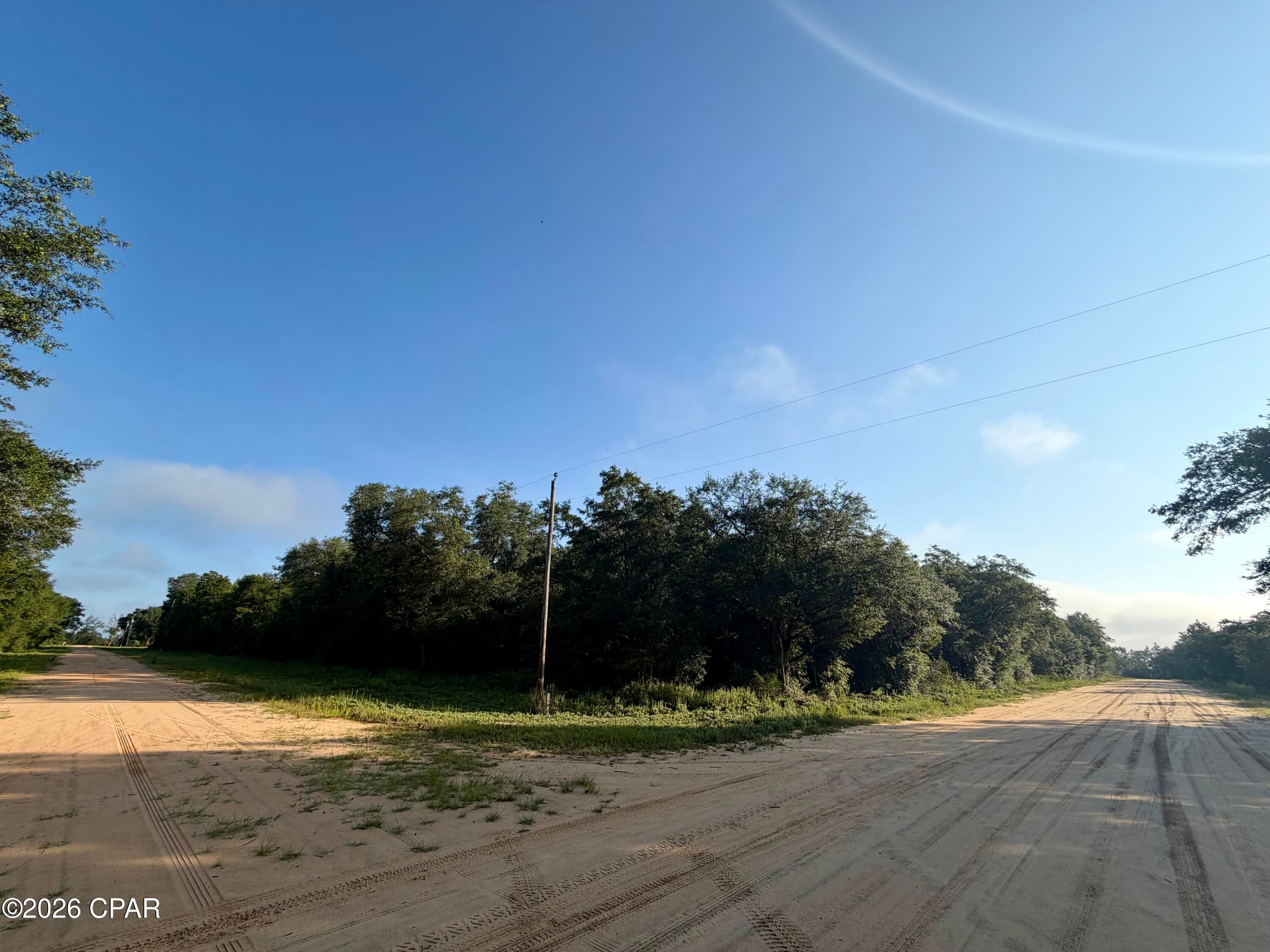 Nice CORNER lot in Compass Lake in the Hills with 1.45 acres!  You can build a home or put a mobile home on this lot. If you're looking for a homesite, there's already power lines in front of this lot.  There is a voluntary POA that's $135 annually. Amenities include a community pool, cabins, RV park, tennis courts, community center, etc.