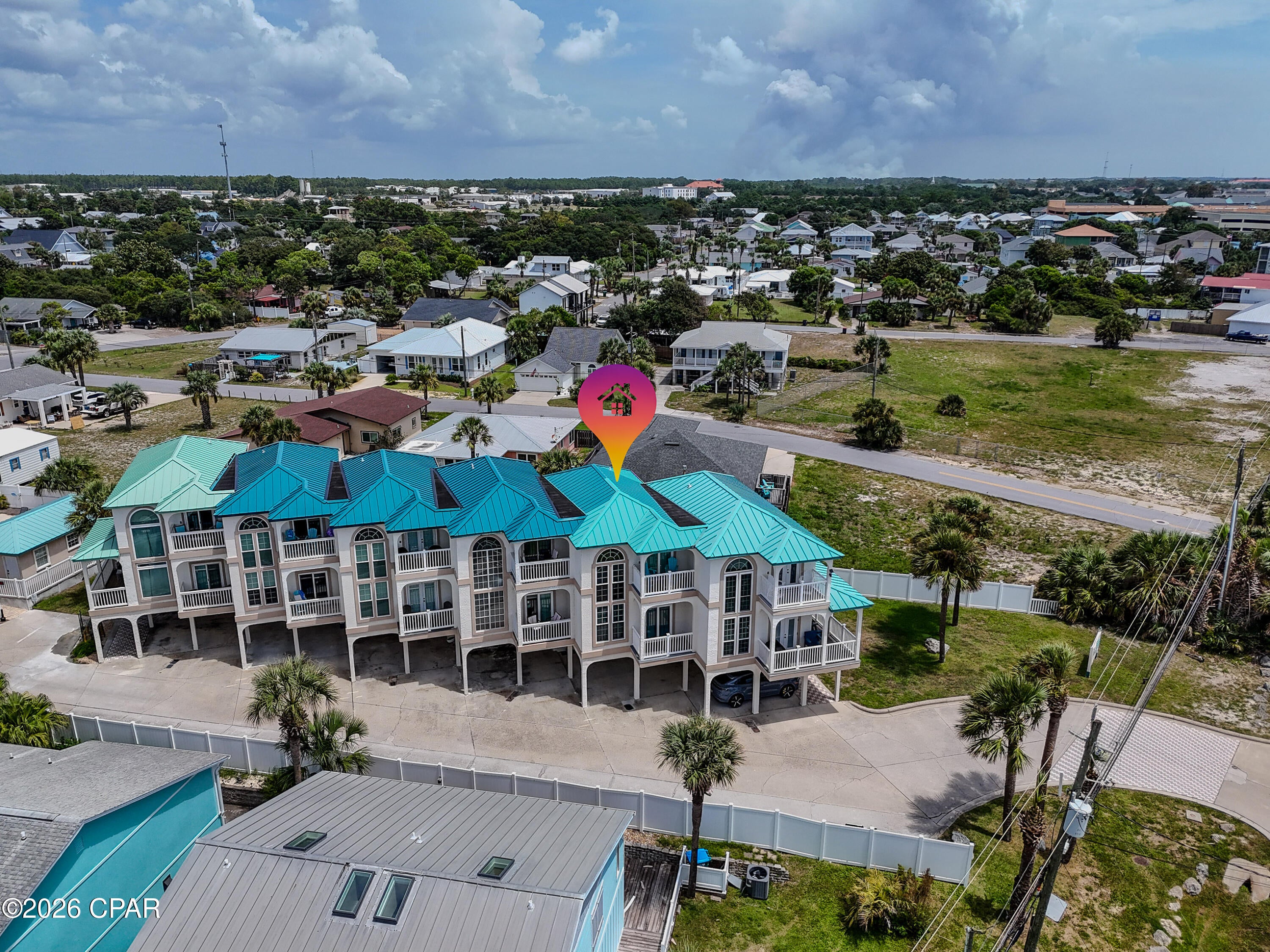 Step across the street and onto the sand! This fully furnished 3-bedroom, 3-bathroom coastal townhome delivers the beach lifestyle paired with exceptional flexibility. Never used as a rental, this townhome offers great investment potential.

1st Floor Flex Suite: A private, studio-style guest quarters featuring a full bath,
kitchenette (refrigerator/microwave), and back patio access. Ideal for guests, in-laws, or lockout rental potential.

2nd Floor Living & Dining: Open-concept main level with a kitchen, dining and living areas, guest bedroom, full bath, laundry room, and a private balcony.

3rd Floor Primary Haven: Dedicated entirely to the primary suite, complete with a versatile loft space, high ceilings, and a private balcony capturing stunning Gulf views and west-end sunsets.

Parking & Amenities: Rare covered two-car parking plus rear complex guest parking. Community amenities include a pool and hot tub.

Situated in a prime location just minutes away from Pier Park, the Thomas Donut & Snack Shop, Carousel Supermarket and much more.