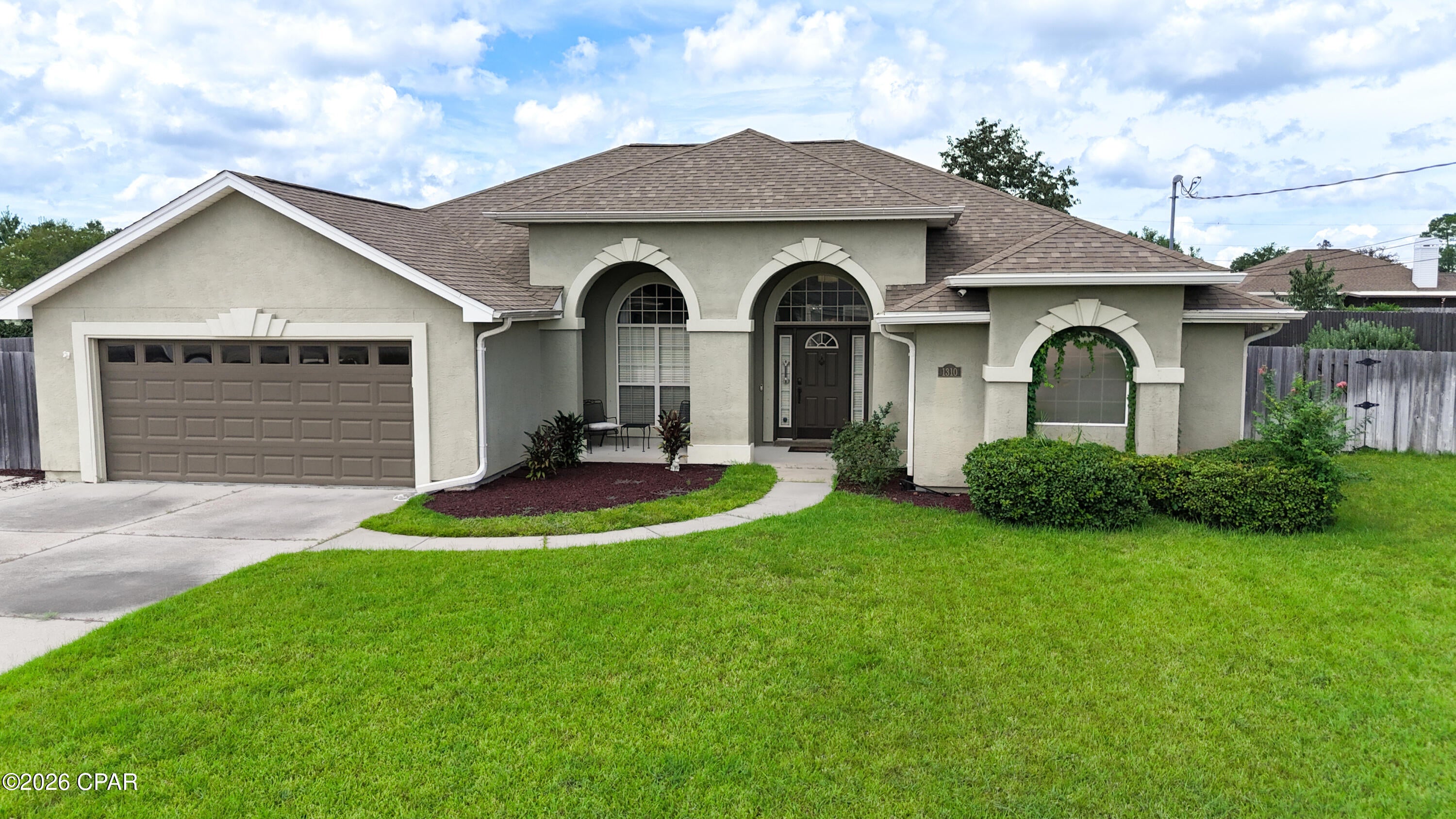 Lynn Haven pool home loaded with upgrades.  This beautifully remodeled home features high-end finishes, a detached 22x22 shop, heated saltwater pool, and an impressive 400-square-foot cabana.

The oversized 40-foot-wide driveway provides plenty of parking. Inside, the open floor plan features 10-foot ceilings, custom colors, and abundant natural light. The updated kitchen includes Shaker-style soft-close cabinetry, Super White quartz countertops, and GE stainless steel appliances, including a Café commercial-style dual-fuel range with 6 burners and double ovens.

The spacious primary suite offers a luxurious bath with a large double shower, rainhead, floor-to-ceiling tile, custom glass, double vanities, marble countertops, with a dedicated water heater.

Large sliding glass doors from the great room and primary bedroom open to the private backyard oasis. The fully landscaped yard features a privacy fence, heated saltwater pool with waterfall, expansive sunning and entertaining area, and a 400-square-foot Tiki hut with hand-scraped cypress beams and metal roof

The detached shop includes an 8-foot double garage door, decked storage attic, and paved driveway access to the front of the property.