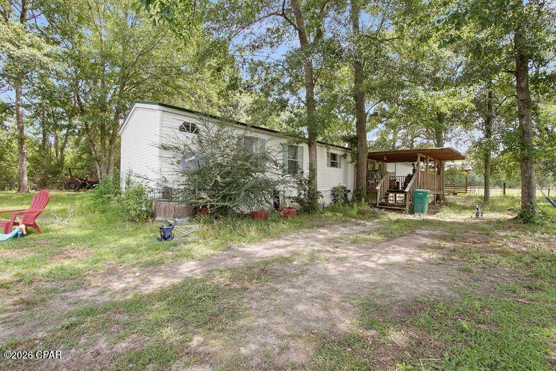CURRENTLY UNDER CONTRACT, SELLER WILL CONSIDER BACKUP OFFERS!!! MOTIVATED SELLER! This is one gorgeous, peaceful piece of country living!! Your sanctuary to be. Perimeter is nearly all cleared and COMPLETELY fenced, with a section cordoned off for horses or cattle. There's also a small creek up front near the road. Pole barn is 60'x24'. There are 6 stalls and a tack/storage area. The barn is electrified with 100 amp service! Additionally, you have a 12x16 storage shed. Some shade trees on the property, as well as a nice little pond approx. 40'x22', 4'-5' deep, with, according to the seller who lived here, bass, catfish, and brim for your own yard fishing pleasure! SW 3-bed, 2-bath with open floor plan is good to go and, according to my most excellent lender, can be financed conventional, VA, or FHA - (We have THE BEST lender ready for you to connect to!) Road is well-maintained and in just half a mile, paved Pioneer Rd. will get you anywhere your heart desires and to all that Northwest Florida has to offer! Call RIGHT NOW and schedule your showing! Seller does not have a survey. (Sellers will be in town 7/13 to get the property spruced up now that occupants have vacated.)