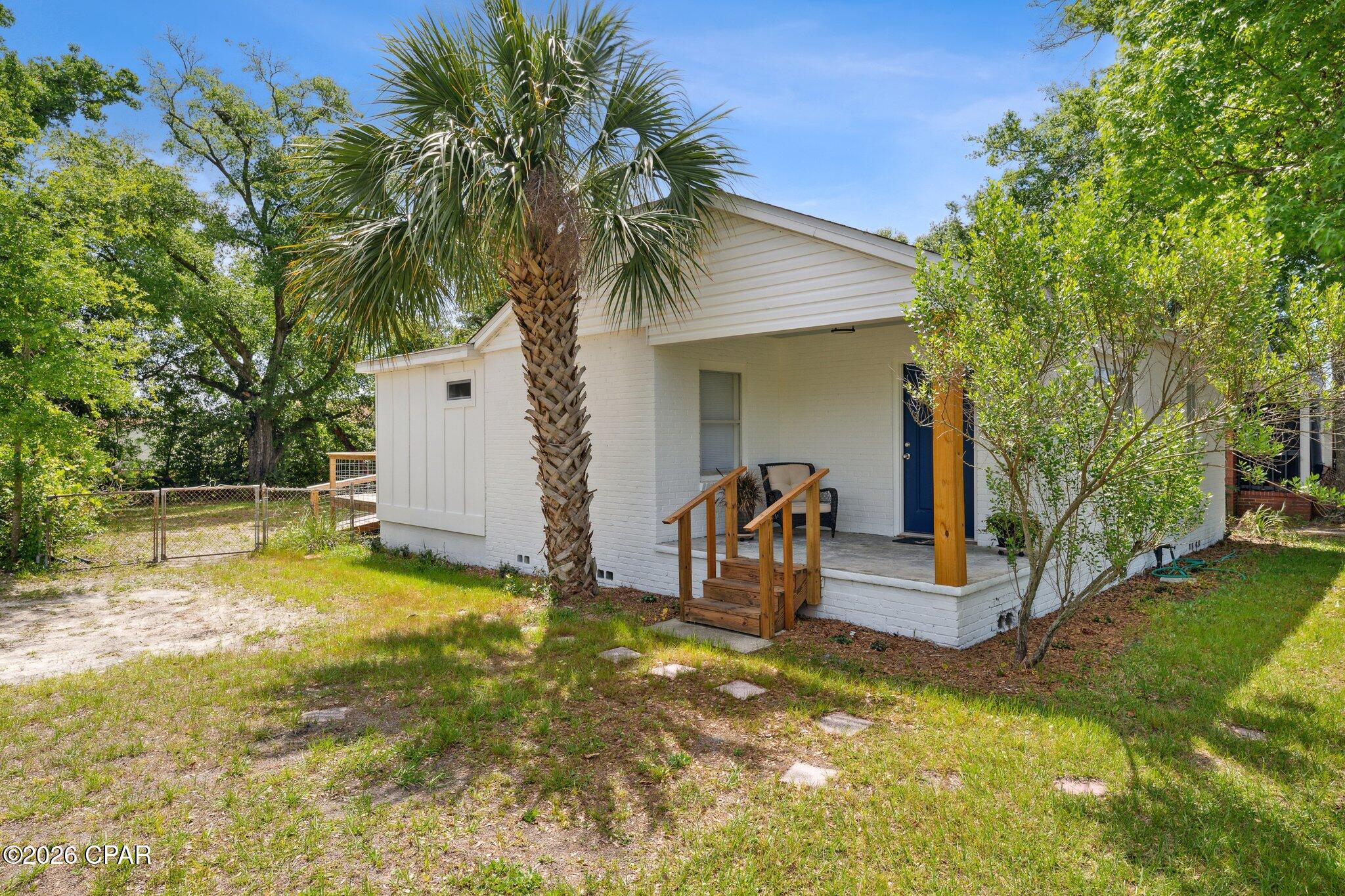BRAND NEW METAL ROOF !! This lovely St. Andrews cottage sits on a large corner lot, is solid brick and is filled with charming details. Gorgeous original hardwood floors in all rooms except the kitchen, dining and florida rooms which have a beautiful slate tile.  This 2br/2ba home could easily be made into a 3br with little effort.  The decorator touches in the bathrooms enhance the charm of this adorable home.  The kitchen has a great flow  and includes newer appliances.  The spacious Florida Room is just off the kitchen and overlooks your yard offering extended living. Enjoy your fenced backyard with  mature trees and large deck for grilling  and entertaiing. Just a couple of minute drive to Old St. Andrews to enjoy dining, shopping, events and sunsets on St. Andrews Bay.  This home is a must see for  a first time buyer, second home or fabulous investment property.