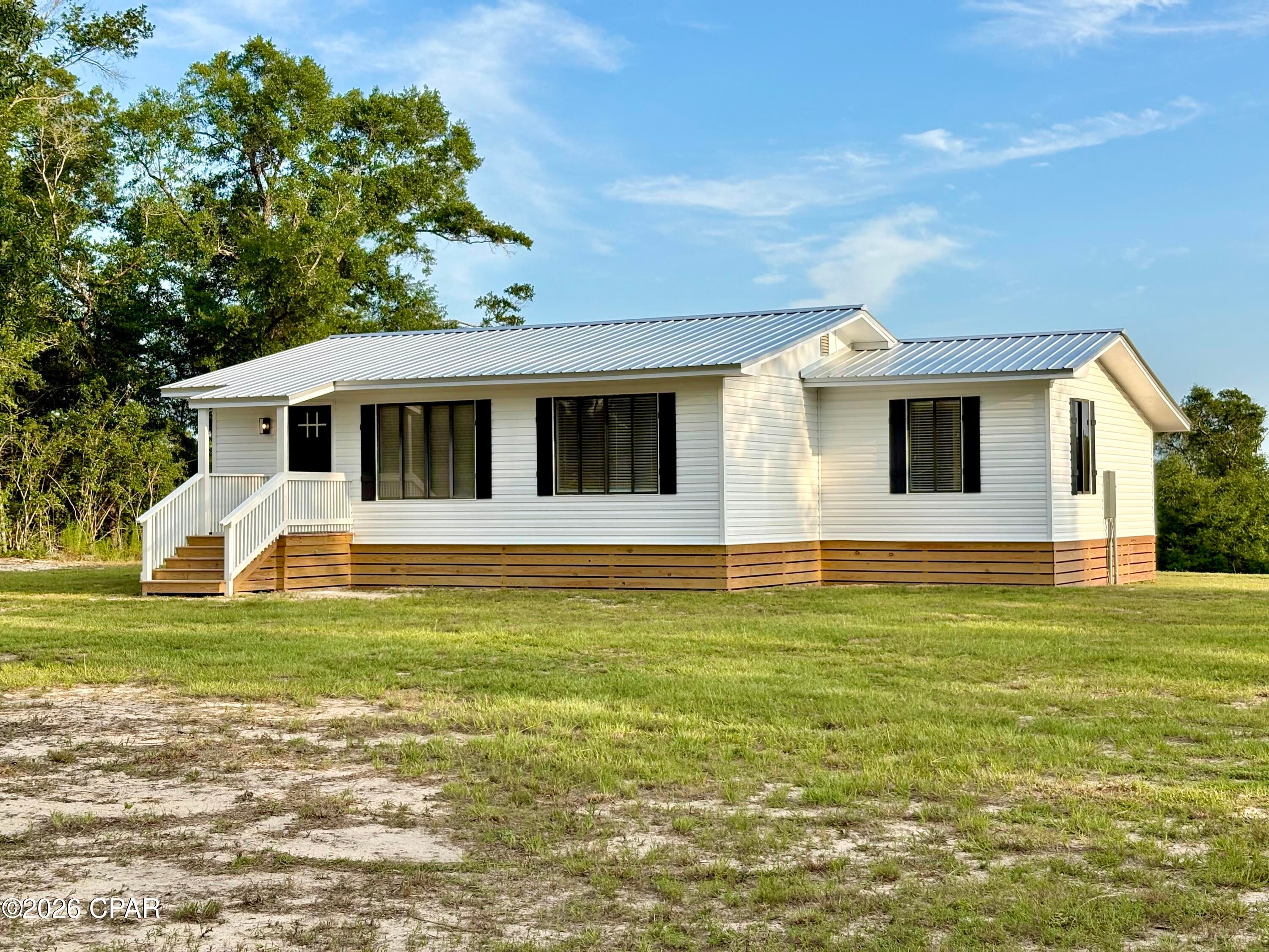 Entered for comp purposes only- Beautifully renovated 1970 2 bedroom 1 bathroom stick built home located on 2.66 acres. Brand new fixtures, utilities, tankless water heater, appliances, floor covering, bathroom, kitchen, laundry room, and more! Move-in-ready. The home was moved to this location and there is a gas line easement running through the rear of the property.