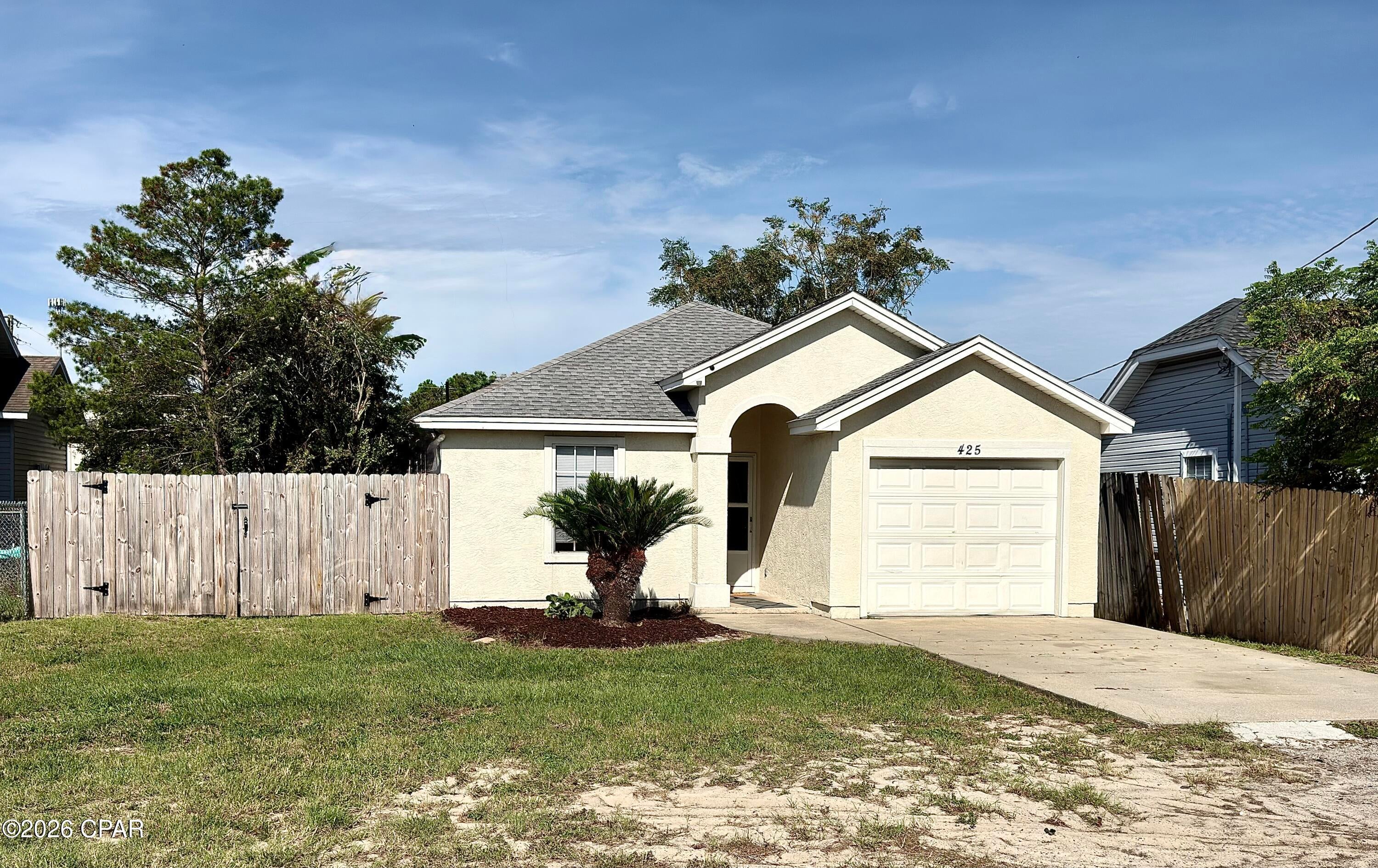 Enjoy the best of west-end Panama City Beach living at 425 Dolphin Drive! Located just 0.6 miles from the beautiful white-sand beaches of the Gulf, this inviting 3-bedroom, 2-bath home offers a great combination of coastal convenience and comfortable everyday living.

The location puts you within minutes of Lake Powell, Camp Helen State Park, and the shops, dining, and beaches of the 30A/Inlet Beach area, while still offering convenient access to Panama City Beach. Publix and additional shopping at Ocean Park Pavilion are also just around the corner, making errands and everyday necessities easy.

At home, enjoy a fully fenced backyard, attached garage, and included washer and dryer. Pest control is also included, giving you one less monthly responsibility to worry about.

Whether you're heading to the beach for an afternoon, exploring nearby 30A, enjoying the outdoor recreation around Lake Powell, or simply relaxing in your own backyard, this home places you in an excellent location to enjoy the coastal lifestyle without being in the middle of the busiest parts of Panama City Beach.

Schedule your showing today and see what makes this west-end location such a great place to call home!