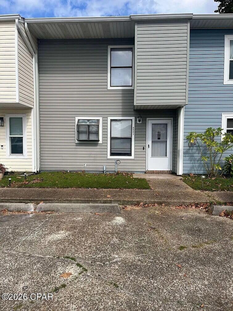 Two-story townhome in Callaway, approximately 10 minutes from Tyndall AFB. 2 bedrooms, 1.5 baths, 1,204 square feet. Currently tenant-occupied and rented at $1,350/month, making this a turnkey rental opportunity for investors. The main level offers a tiled living area and a kitchen with granite countertops, white cabinetry, a tile floor, and a garden window over the sink, plus a half bath. Both bedrooms are upstairs with walk-in closets, served by a full bath with a tiled walk-in shower and skylight. In-unit laundry. The fenced backyard includes a patio and outdoor storage. Central heat and air. Convenient to shopping, dining, and the base.