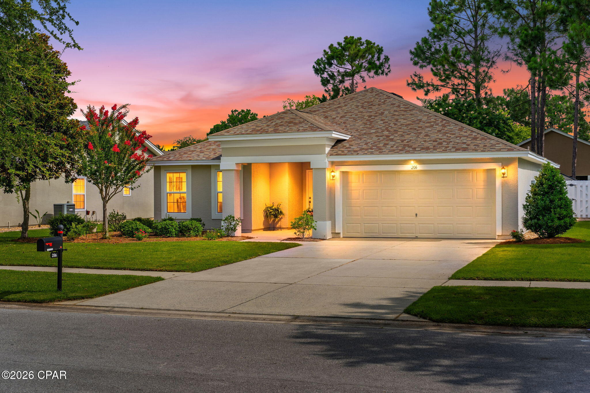 Welcome to Palmetto Trace, a golf cart-friendly community offering convenient access to Pier Park, Frank Brown Park, and the white sand beaches of Panama City Beach. Residents enjoy sidewalks throughout the neighborhood, flowering trees, pet-friendly walking areas, two community pools, low quarterly HOA dues, and garbage service provided by the HOA.

This well-maintained home features a split-bedroom floor plan with spacious bedrooms and an inviting layout. The kitchen offers a large pantry, newer appliances, and a sunny breakfast nook overlooking the peaceful backyard where mature flowering trees create a beautiful setting throughout the seasons.

Step outside to the screened porch, an ideal place to enjoy Florida's outdoor lifestyle while taking in the backyard views and local wildlife. The oversized two-car garage provides ample space for vehicles and additional storage.

Recent updates include a roof installed in December 2018 with a 40-year shingle, a water heater replaced in June 2023, and a freshly painted exterior. Pride of ownership is evident throughout this exceptionally cared-for home, offering a move-in ready opportunity in one of Panama City Beach's most desirable communities.
