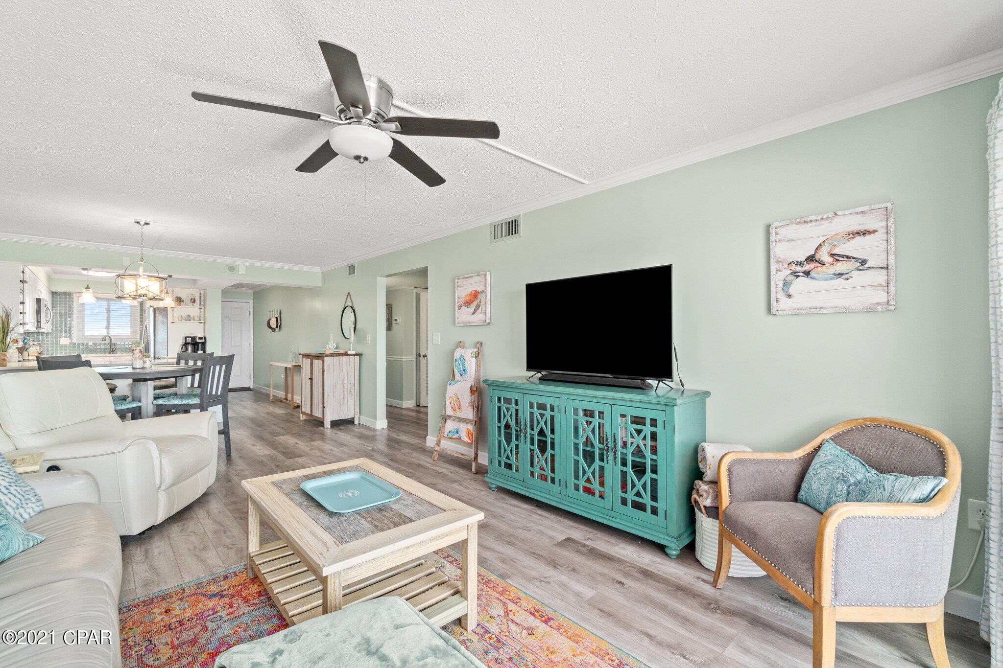 Own a slice of Paradise at the World's most beautiful beach!  This professionally remodeled, tastefully decorated 2 bedroom 2 bathroom condo is a MUST SEE!  The upgrades are fabulous!  Brand new stainless steel appliances, wine rack, coffee bar, soft close cabinets & drawers, led lighting, quartz countertops & tile backsplash in the Kitchen, breakfast bar with stools, brand new leather sofa, recliner and lounger.  Beautiful new outdoor patio furniture.  Luxury Vinyl Plank flooring. The bathrooms are fantastic, walk in tile shower off Master and tile bath in guest bathroom.  Brand new sliding glass doors and windows!!!  Priced right and ready to sell!  Would be perfect for primary or vacation home.