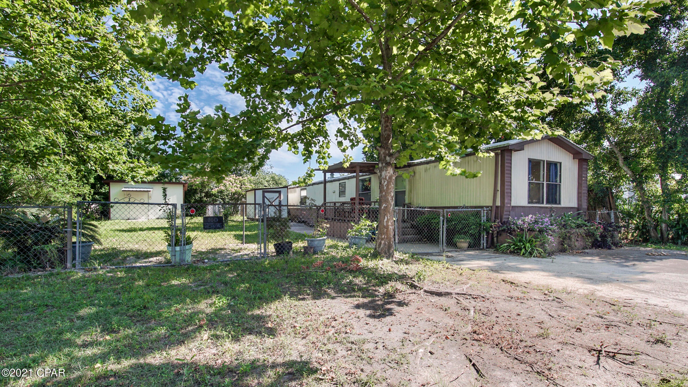 CURRENTLY UNDER CONTRACT, SELLER ACCEPTING BACKUP OFFERS Great investment opportunity! Beautiful homesite with ready to move in mobile home. Two bedrooms, two baths with refrigerator and washer and dryer! Roof redone in 2019. Large lot with mature trees and 2 storage buildings.  One has water and electric and houses the washer and dryer. Centrally located and convenient to all things Beach!!