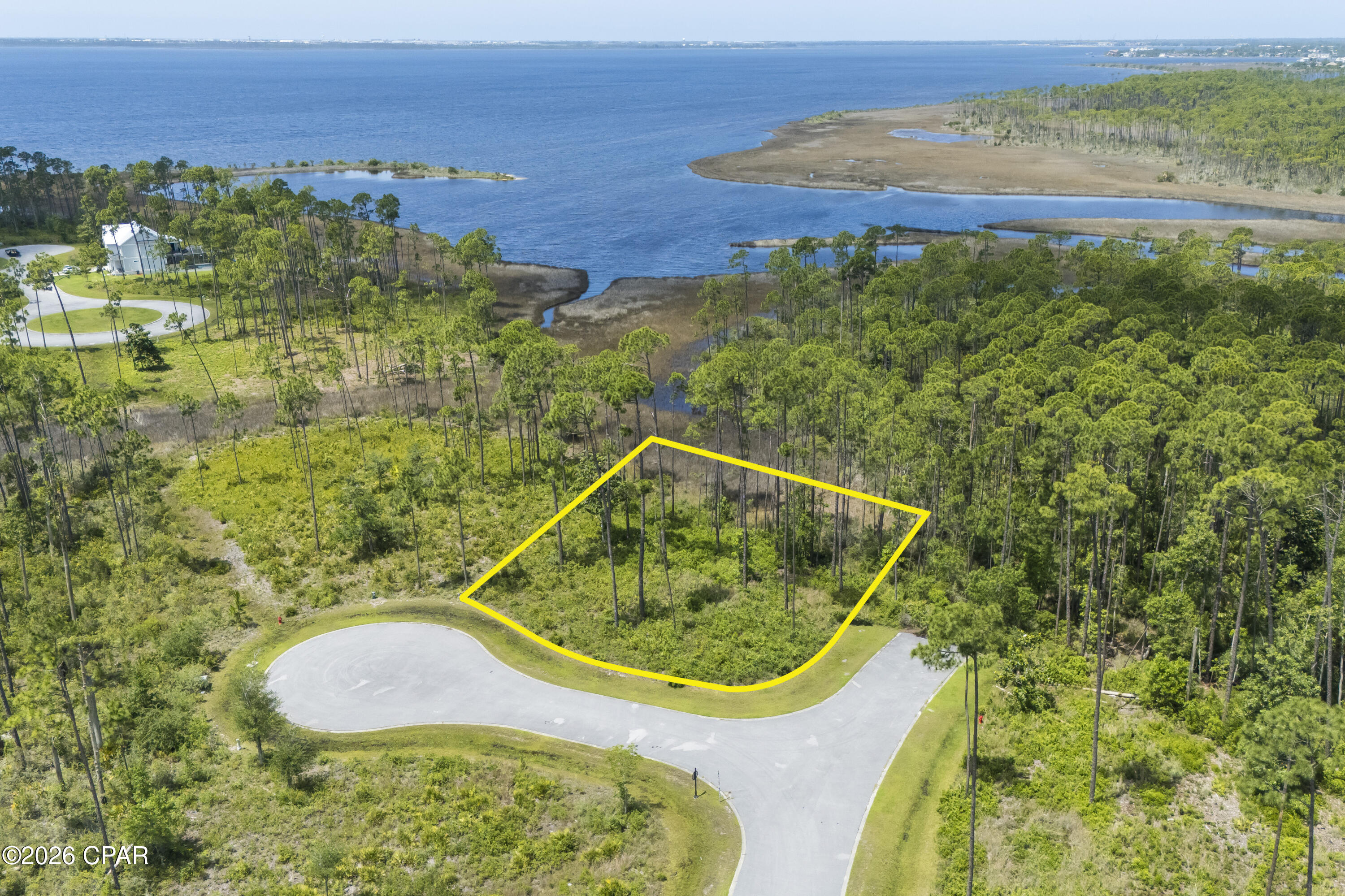 Welcome to 900 Lanyard Court, a beautifully positioned homesite in the highly desirable Laird Point Phase I community. Nestled on a quiet cul-de-sac, this property offers the perfect blend of privacy, natural beauty, and coastal charm.

Situated within a gated, bayfront neighborhood, residents enjoy access to exclusive amenities including a private waterfront park, community dock, and serene nature trails--ideal for kayaking, fishing, or simply soaking in breathtaking sunsets over East Bay. Electrical and sewer connections are available, making this an ideal location to build your dream home with ease.

This homesite provides a peaceful retreat while still being conveniently located just minutes from shopping, dining, and the white-sand beaches of Panama City Beach. Whether you're looking to build a full-time residence or a coastal getaway, this property delivers the best of Florida living.

Don't miss the opportunity to own in one of the area's most sought-after waterfront communities where tranquility meets convenience.