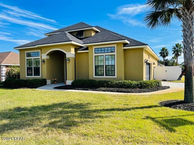 CURRENTLY UNDER CONTRACT. SELLER ACCEPTING BACK -UP OFFERS. Corner lot with an inground pool and privacy fence.  Located in one of the most sought-after subdivisions in Panama City Beach within walking distance of the beach. Golf Cart Friendly Neighborhood. Great access to Pier Park, airport, shopping, restaurants & entertainment. Hardwood style floors throughout the home with carpet in the bedrooms. Granite countertops, custom cabinetry, all commercial grade stainless steel Frigidaire appliances in kitchen area along with 6'' crown molding & baseboards. Custom French doors greet you as you enter the home, and all of the doors are solid core. The open patio is wired for surround sound & the home has large plantation shutters. Curtains not included. Freshly painted with elastomeric pain