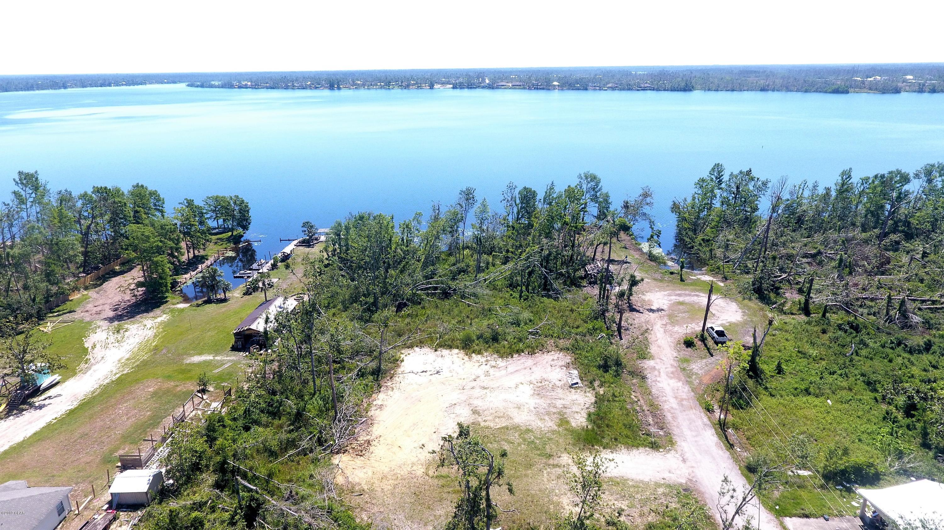 ABSOLUTE STEAL!!!  Motivated Sellers so come take a look at this 1.5+ acre parcel located directly on Panama City's best bass fishing lake and fall in love with the future location of your dream home.  This property is located at the end of a paved road and abuts Deerpoint Lake that is know for it's fishing and watersports.  The lake is fed by 4 contributors, including spring fed Econfina, and flooding is never a worry due to the dam and the gates used to evacuate the lake.  The parcel features a cleared area that has had fill dirt applied for a home pad and also includes the wooded area all the way to the lake that can be shaped into whatever a buyer would like.