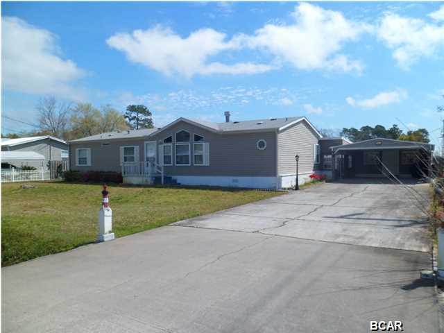 Back on the market and ready to move-in! Cozy, immaculate, conveniently located to everything and ready to move in! This mobile home is neat as a pin and has so much to offer. A split floor plan with 3 bedrooms, 2 baths, over 1600 square feet, a spacious family room with fireplace, dining room, and large kitchen with tons of cabinets and counter space - even an Island in the middle with more storage. All appliances convey with the purchase of this home and the sellers are also leaving the washer and dryer. The master bedroom has a walk-in closet and huge master bath with French doors, soaking tub, separate shower, and double vanity. The other bedrooms have a spacious bath between them. These bedrooms also have walk-in closets. The laundry room feeds off an air conditioned Florida