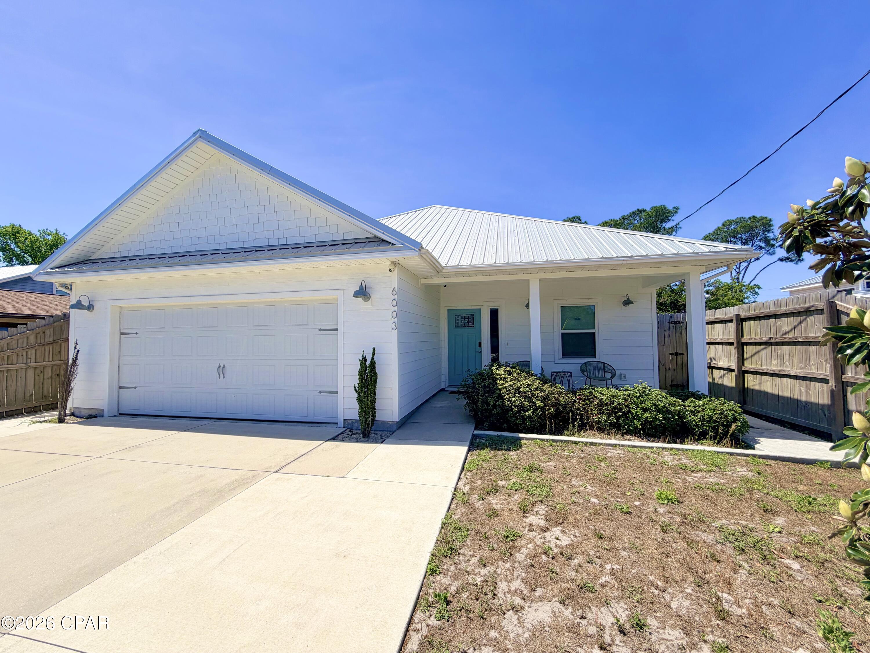 Welcome to laid-back coastal living in the South Lagoon area of Panama City Beach where beach days, boating adventures, and golf cart rides become part of everyday life. This beautifully designed beach house blends durability, style, and comfort with an all Hardie Board exterior, a striking metal roof, and a spacious two-car garage. With plenty of room for beach gear, water toys, and extra storage. Inside, the home feels fresh, bright, and inviting with soaring trey ceilings, luxury vinyl plank flooring in a hand-scraped finish, and soft coastal-inspired colors that instantly create a relaxed vacation atmosphere.

A well though out split floor plan offers privacy for the spacious primary suite, complete with an attractive ensuite bath and generous walk-in closet. The heart of the home is the open-concept kitchen and living area, featuring quartz countertops, stainless steel appliances, and plenty of room to gather with family and friends after a day on the water or at the beach. Every detail was selected with both style and easy coastal living in mind.

Located in a fun, golf-cart-friendly neighborhood with no HOA and no flood insurance required, this home offers the freedom to truly enjoy the Panama City Beach lifestyle. Spend mornings launching the boat from one of two nearby public boat ramps, afternoons soaking up the sun on the sugar-white beaches just a short walk away, and evenings cruising the neighborhood by golf cart to local restaurants, marinas, and entertainment. Whether you're searching for a full-time residence, vacation getaway, or investment property, this South Lagoon gem delivers the perfect combination of beach charm, convenience, and everyday paradise. Schedule a private tour today, fall in love and make an offer!