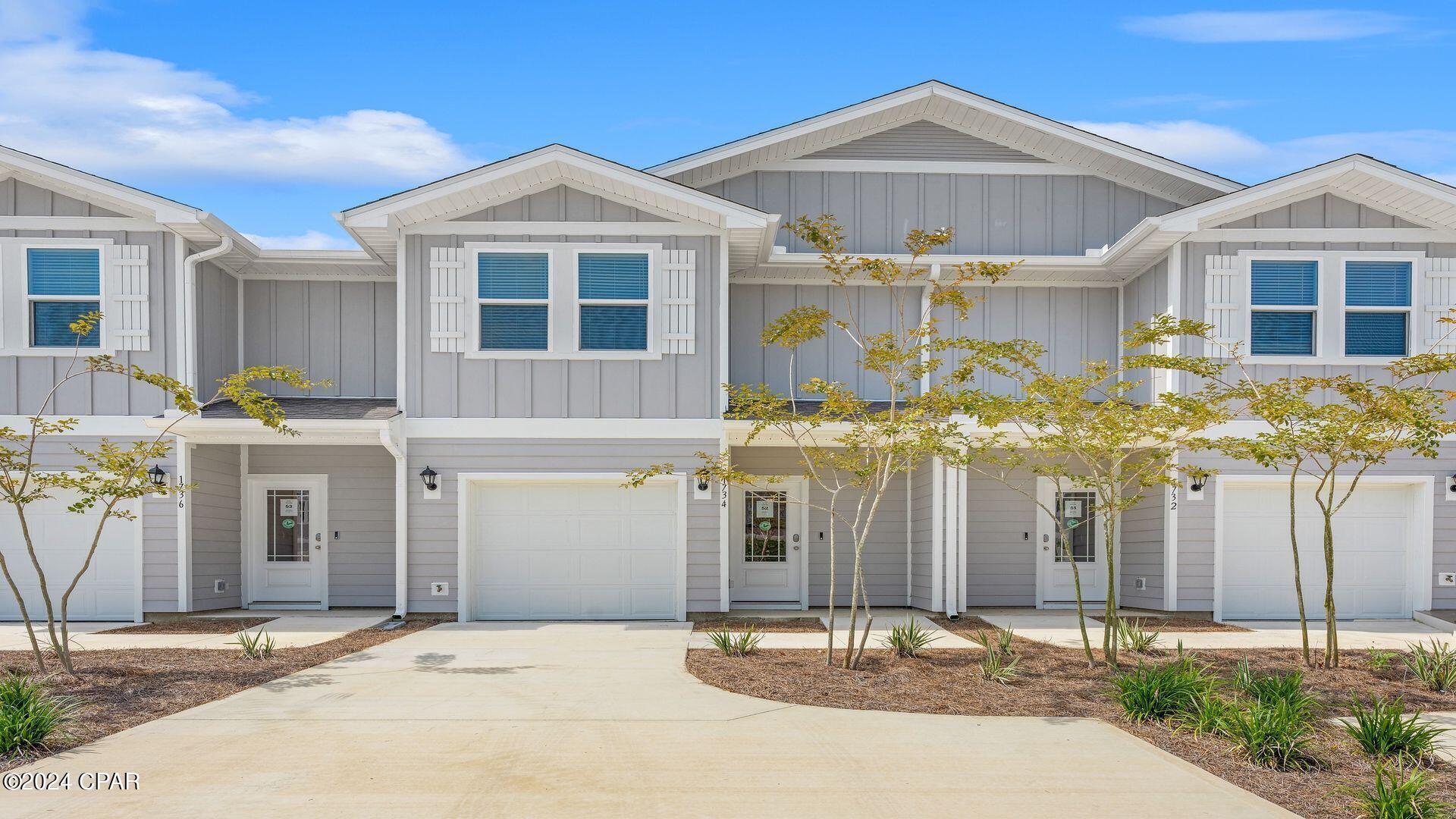Welcome to Jake's Landing townhomes. This interior unit located at 1722 Jakes Drive offers 3 bedrooms and 2.5 bathrooms and a single car garage. On the outside of these units, you will see quality Color-Plus Hardie Board exteriors, complemented by prairie-style doors and dimensional shingles with a 30-year warranty. Convenience meets security with steel garage doors equipped with openers, weatherproof outlets, hose bibs, and a fully sodded yard where cleared. As you enter inside, you will feel right at home with beautiful EVP flooring at your feet, leading you to the open living room and kitchen or the spacious upstairs. In the kitchen and bathroom, you will find gorgeous granite countertops, white cabinets with brushed nickel hardware, and a full stainless steel appliance package including a stove, microwave, dishwasher refrigerator, washer and dryer. Stay cool with energy-efficient cooling and heating systems, Low-E insulated windows with screens, and ceiling fans in the living room and primary bedroom as well as blinds installed throughout the home. Each home comes with modern Smart Home technology including a Skybell doorbell, Honeywell thermostat, and Smart Switches. An additional convenience is that landscaping and lawn maintenance is included. Rest assured with a one-year builder's warranty and a ten-year structural warranty through RWC. Located in the lovely city of Lynn Haven, Florida, you are not far from great food, shopping, schools, hospitals, and more. These homes offer easy access to Tyndall Air Force Base (just a 20-minute drive) and the world-famous white beaches of Panama City Beach (20 minutes away).