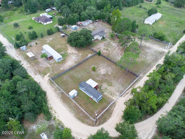 Outstanding multifamily investment opportunity with exceptional potential! This 2.5-acre corner parcel in Southport, Florida, features three income-producing mobile homes and is ideal for investors looking to expand their rental portfolio. The seller is retiring, creating an excellent opportunity to own a property with established rental history and future upside.

Conveniently located just 11 miles (approximately 15 minutes) from Lynn Haven, the property offers a peaceful setting with easy access to shopping, dining, schools, and everyday conveniences. The surrounding area includes established neighborhoods such as Lake Merial, White Oaks, and Skunk Valley.

The mobile homes are older and could benefit from some TLC, but they have provided consistent rental income for many years. Previous rental rates were $750/month, $550/month, and $675/month, with long-term tenants in place. The seller believes current market conditions may support higher rental rates, offering additional income potential.

Whether you choose to continue operating the property as a rental investment, renovate the existing homes, or take advantage of the beautiful corner parcel to build your dream home, this property offers flexibility and numerous possibilities. Don't miss this unique opportunity to own acreage with income potential in a desirable and growing area.  Property and home dimensions are approximate.