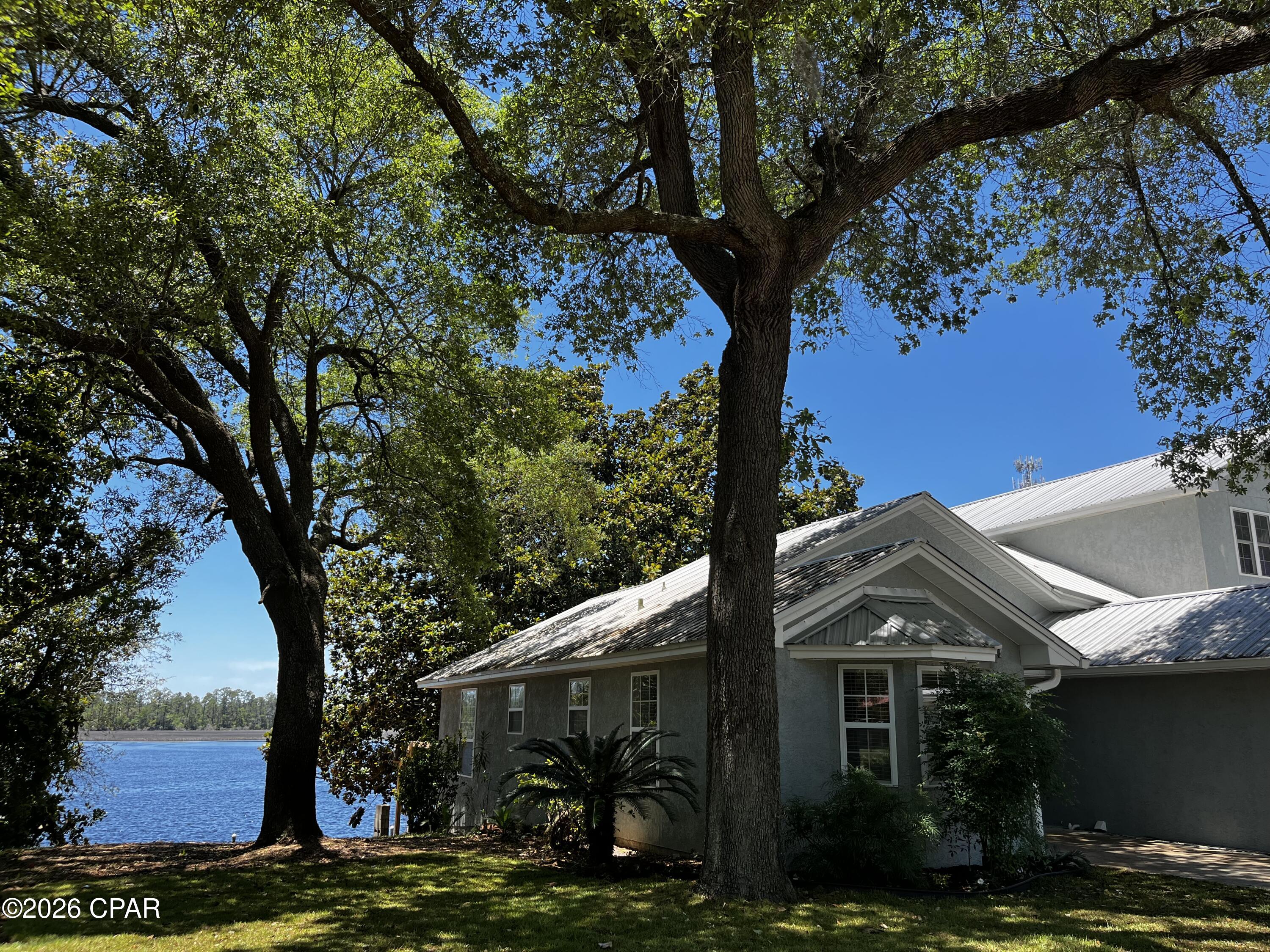 Fisherman's Paradise with Direct GULF ACCESS and no HOA!  WATERFRONT on Burnt Mill Creek. This unique property offers the ultimate laid-back Florida waterfront lifestyle. Launch your boat right from your backyard, cruise out to Shell Island, fish from your private dock, or enjoy kayaking, paddleboarding, and jet skiing whenever you want.

 The spacious waterfront home has water views from almost every room, a large living area that opens to the Florida room, an updated kitchen with granite and custom cabinetry, a screened back porch, plenty of storage. There are two master suites, both with gorgeous water views. The primary suite on the second floor even has its own private screened balcony overlooking the water.

 Two docks give you plenty of space for boats and water toys, including a covered boathouse with motorized boat lifts and jet ski lift. Enjoy the most beautiful sunsets from the swing on the dock. 

 There's also a fish-cleaning station with power and water to clean the day's catch. 

 Fishing here is excellent, with bass and bream up the creek, redfish and flounder in the bay, and speckled trout right out your back door when winter rolls around.

 Outside, you'll find shaded decks under mature magnolias, two storage sheds, and a 25' x 20' Carolina carport built in 2024.

 There's also a separate 1-bedroom, 1-bath cottage with a tenant already in place, giving you immediate rental income. Short-term rentals are allowed.

 With about 3,667 square feet, there's plenty of space for family, guests, or income opportunities. Super convenient location--just 7 minutes to the airport, 15 minutes to the beach and Lynn Haven, 25 minutes to 30A, and 30 minutes to downtown Panama City.

 Fish, boat, explore Shell Island, and relax. This is Florida waterfront living at its best.

 All measurements are approximate and should be verified if important.