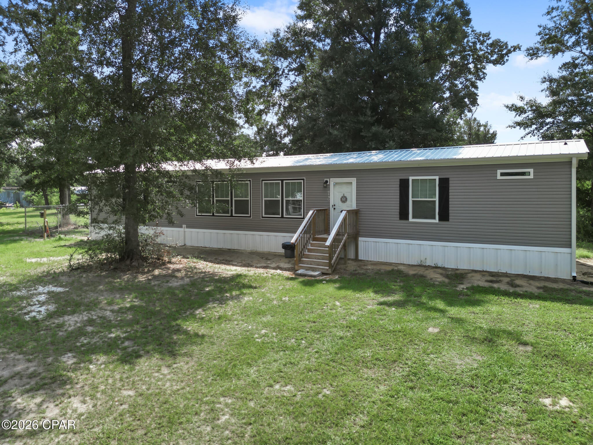 Tucked back from the road on a spacious  lot, this immaculate 2024 3-bedroom, 2-bathroom home delivers a turn-key opportunity with zero work left to do.The light-filled interior features a highly desirable split-floor plan.  This property includes a spacious open-concept main living area, bright kitchen complete with an island and durable metal roof overhead. The seller has recently invested in premium property upgrades, including a brand-new fenced-in yard ready for pets, a detached metal building perfect for your extra storage, and a newly installed whole-house water filter system.  Conveniently located in Kinard, this property is less than 45 minutes from the coast. If you are looking for a peaceful homestead, this move-in-ready property is a must-see!