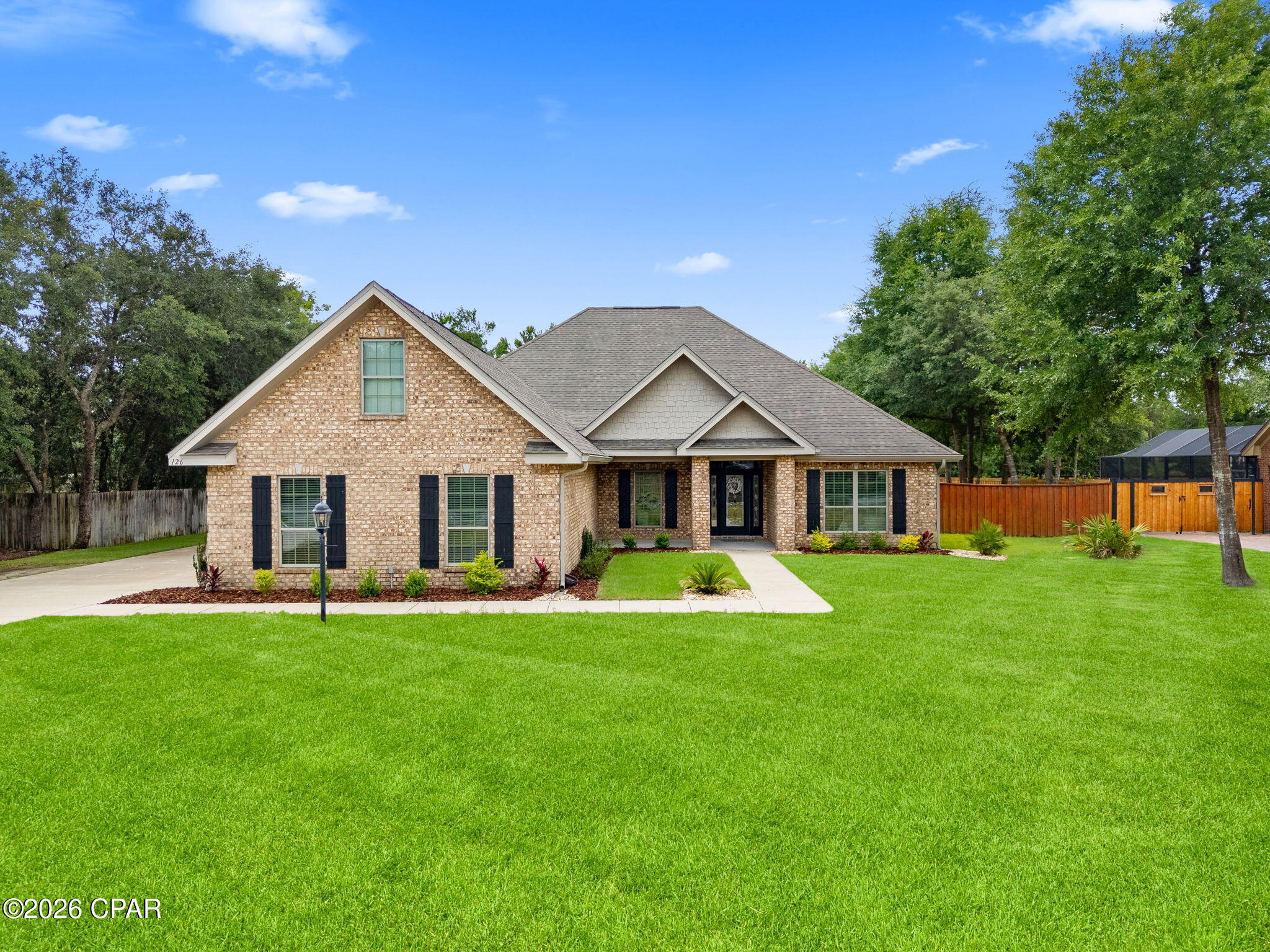 PRICE REDUCED! 

The seller is offering a one-year home warranty PLUS $5,000 toward the buyer's closing costs with an acceptable offer. This is an incredible opportunity to own a beautifully custom-built home in the highly sought-after gated community of Lake Merial at an even better value. Don't miss your chance to enjoy luxury living, an incredible backyard oasis, and all the amenities this wonderful neighborhood has to offer!

Welcome to this stunning custom-built home located in the highly sought-after gated community of Lake Merial, where oversized homesites, peaceful surroundings, and natural beauty create the perfect blend of privacy and convenience. Enjoy a quiet, tucked-away setting while remaining just a short drive from shopping, dining, and the white sandy beaches of the Gulf Coast. Residents of Lake Merial also enjoy private access to the lake for kayaking, paddleboarding, fishing, or simply unwinding by the water.

Situated on a spacious lot, this beautifully maintained craftsman-style home offers an exceptional layout designed for both everyday living and entertaining. The backyard is truly a showstopper featuring a stunning custom pool surrounded by gorgeous landscaping, creating your own private resort-style retreat. Whether you are hosting summer gatherings, enjoying evenings under the screened-in patio, or watching the kids play in the expansive fenced backyard, this outdoor space was made to be enjoyed. A double gate provides added convenience for boat or recreational vehicle storage.

Inside, the home features five generously sized bedrooms along with two versatile flex spaces perfect for a home office, playroom, media room, gym, or guest retreat. The open-concept floorplan offers warm hardwood flooring throughout the main living areas, comfortable bedroom spaces, and an abundance of natural light. The kitchen is beautifully appointed with granite countertops, stainless steel appliances, ample cabinetry, and plenty of prep space for entertaining and family gatherings.

The spacious primary suite serves as a relaxing escape with a luxurious ensuite bathroom featuring a soaking tub, separate walk-in shower, and oversized walk-in closet. Upstairs above the spacious three-car garage, you'll find additional flex space ideal for a private bonus room, guest retreat, or multi-generational living setup. The oversized garage itself offers plenty of room for vehicles, golf carts, storage, or workshop space.

From the incredible outdoor oasis to the thoughtfully designed interior, this home offers the perfect combination of comfort, style, and functionality in one of the area's most desirable gated communities.