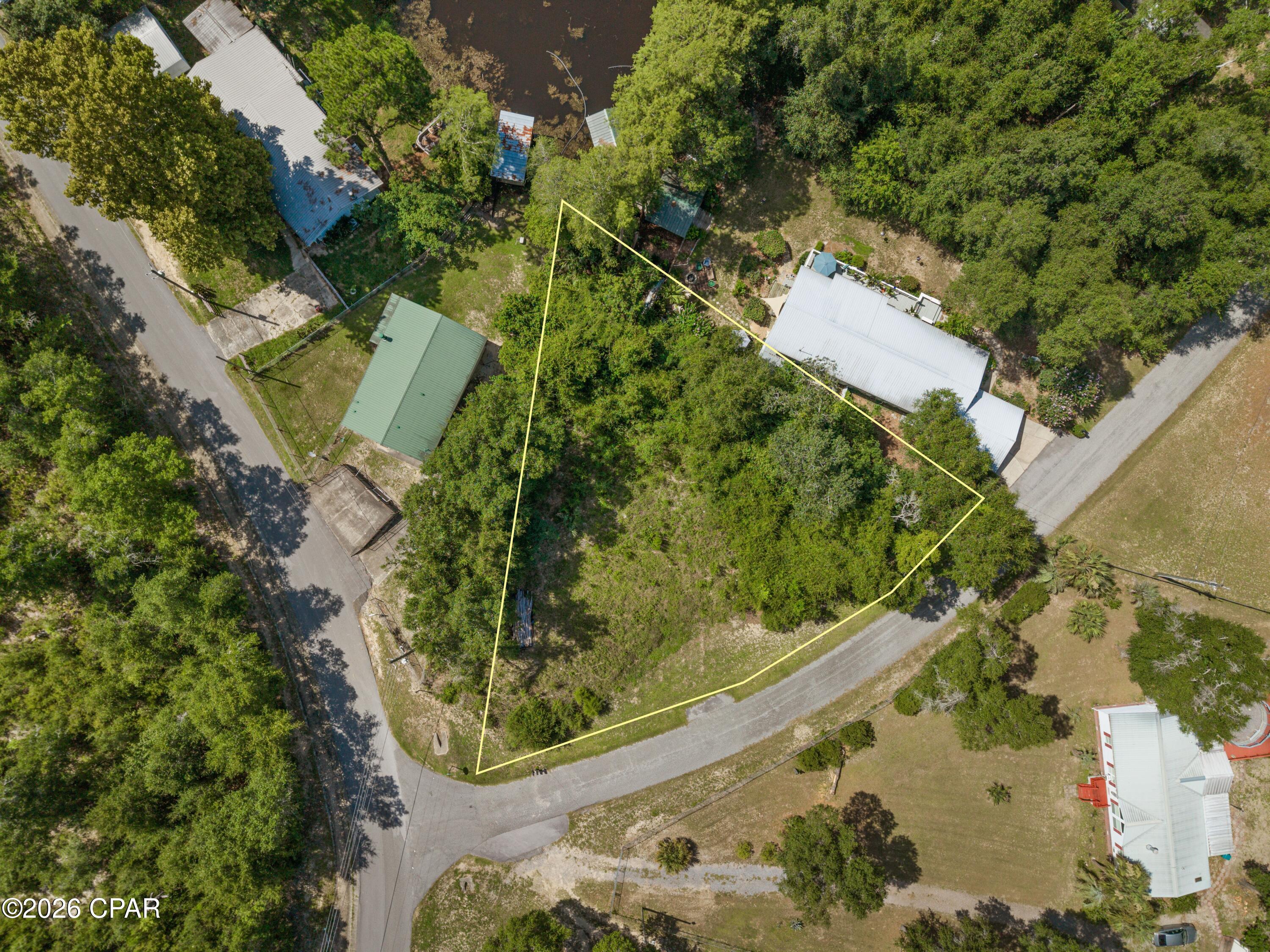 Waterfront lot on a spring-fed lake only 45 minutes from Panama City or Dothan! Well and septic tank are on the property, buyer to verify condition. Boundary lines are estimates.