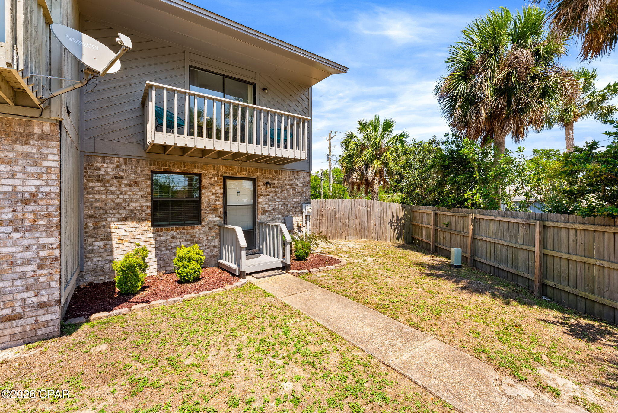 Beautifully maintained 2 bedroom, 1.5 bathroom end unit townhouse featuring a waterview of Callaway Bayou from the primary bedroom balcony. This spacious unit offers beautiful LVP wood flooring throughout the living room and bedrooms, ceramic tile flooring in the kitchen and dining area, and a beautiful large open living room that opens up to a screened patio. The kitchen features stainless steel appliances, tons of cabinet and countertop space with recent updates in last 6 years. Enjoy outdoor living with a screened back patio, additional exterior storage closet, open concrete patio, and a well sized privacy fenced backyard. As an end unit situated on the largest corner lot in the complex, this property offers additional outdoor space and privacy. Additional updates include exterior paint, a water heater replaced between 2022 and 2023 and gutters added along the rear of the home for improved water drainage. Conveniently located near local amenities, dining, shopping, and waterfront recreation.