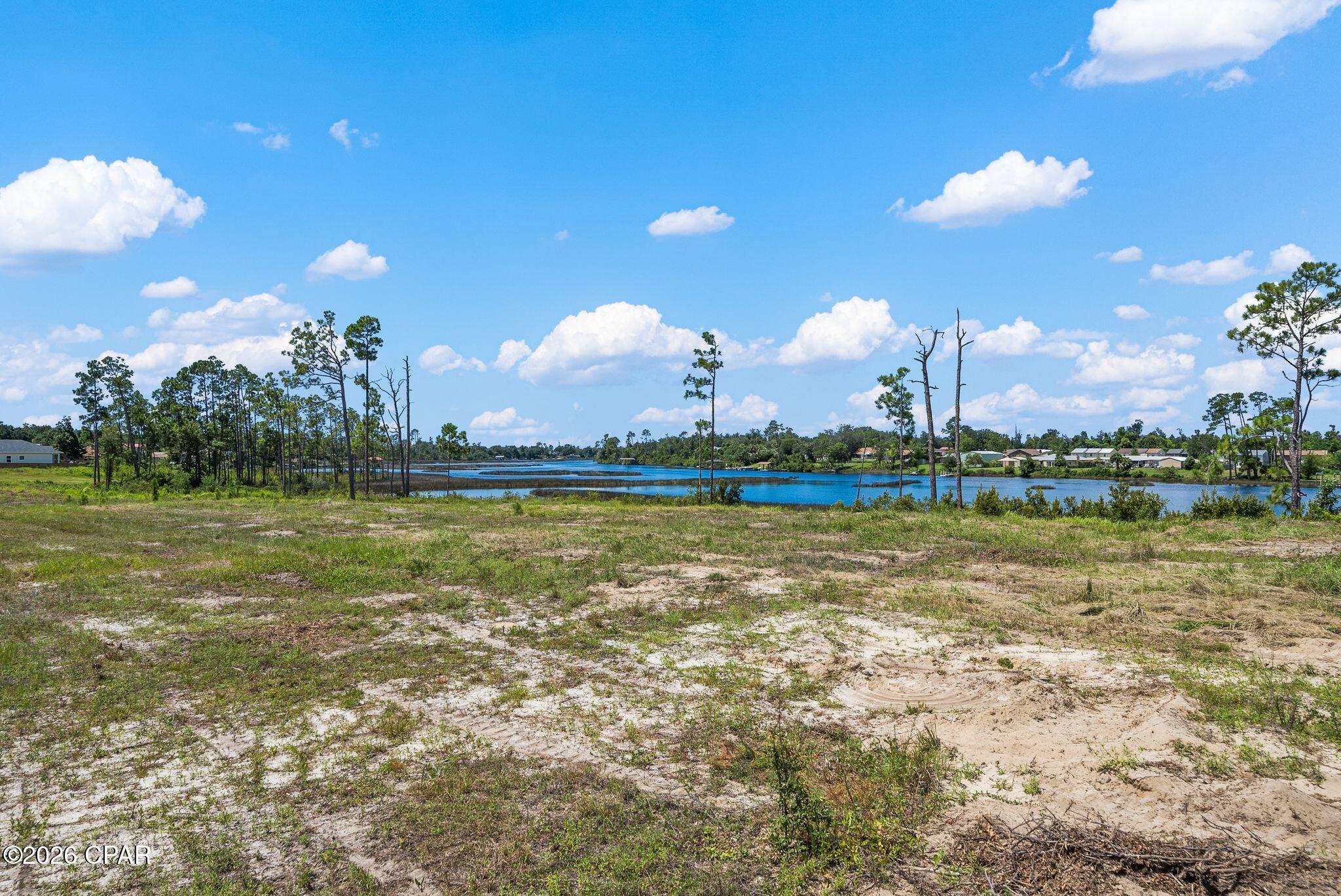 Waterfront development opportunity on Callaway Bayou! Recently subdivided from six parcels into 12 waterfront lots, each offering more than 50 feet of frontage along the bayou and waterfront views. Lot sizes range from approximately 0.152 to 0.29 acres, with most measuring around 0.20 acres.

All 12 lots are being offered together and include the following six parcels: 06641-995-250, 06641-995-260, 06641-995-270, 06641-995-280, 06641-995-290 and 06641-995-300.

Callaway Bayou provides access toward East Bay and St. Andrews Bay, with the shallow-water setting well suited for kayaks, paddleboards, jon boats and other low-draft watercraft, subject to current water depths and conditions. No docks or seawalls are currently in place. Individual dock potential may exist subject to applicable permitting and regulatory approval.

Conceptual home renderings are available illustrating the potential for two-story residences designed to take advantage of the waterfront setting and elevated views. Based on preliminary planning, lots may accommodate approximately 1,800-2,100 square feet of living space with a two-story design. Current information indicates approximately 25-foot roadside setbacks and 20-foot waterfront setbacks; buyers should independently verify zoning, setbacks, building requirements, utilities, flood zone/elevation requirements, dock permitting and intended use with the appropriate governmental agencies.

With 12 individual waterfront lots available, this property presents an opportunity for builders, developers or investors looking to create a cohesive waterfront residential project in the Callaway area, with convenient access to Panama City and Tyndall Air Force Base.