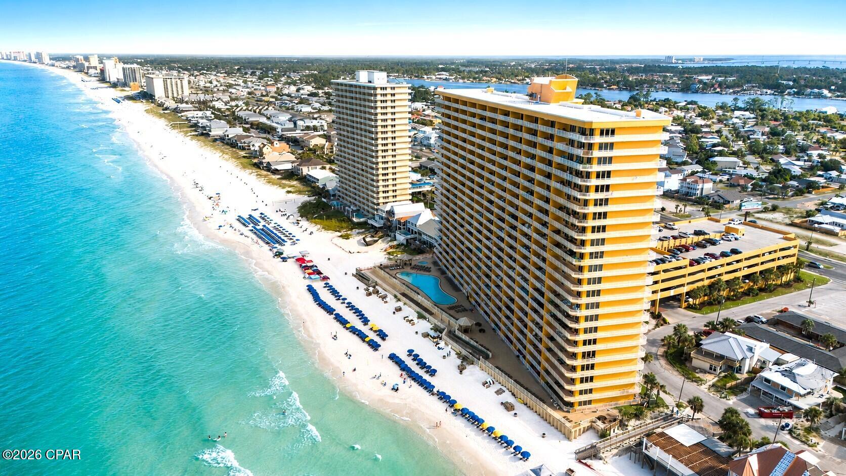Welcome to Unit 1712 at Treasure Island Resort, the best-priced 3-bedroom unit in the building! This spacious 1,950 sq. ft. 17th-floor corner unit offers incredible Gulf and Grand Lagoon views and excellent potential as a vacation rental, second home, or coastal retreat. Thoughtfully designed to accommodate up to 10 guests, the unit features floor-to-ceiling windows, a full-size pool table, dart board, custom bar area, and a unique nautical-inspired interior that sets it apart from the typical beach condo. The primary suite showcases expansive Gulf views, while the additional bedrooms overlook the Grand Lagoon. Located on the quieter east end of Panama City Beach along Thomas Drive, Treasure Island offers direct beach access, a large heated Gulf-front pool, covered parking, high-speed elevators, poolside dining, and a convenient location near Schooners, St. Andrews State Park, marinas, dining, and entertainment. With its oversized floor plan, desirable corner location, high-floor views, strong guest capacity, distinctive design, and competitive price, Unit 1712 offers an outstanding opportunity in Treasure Island Resort.