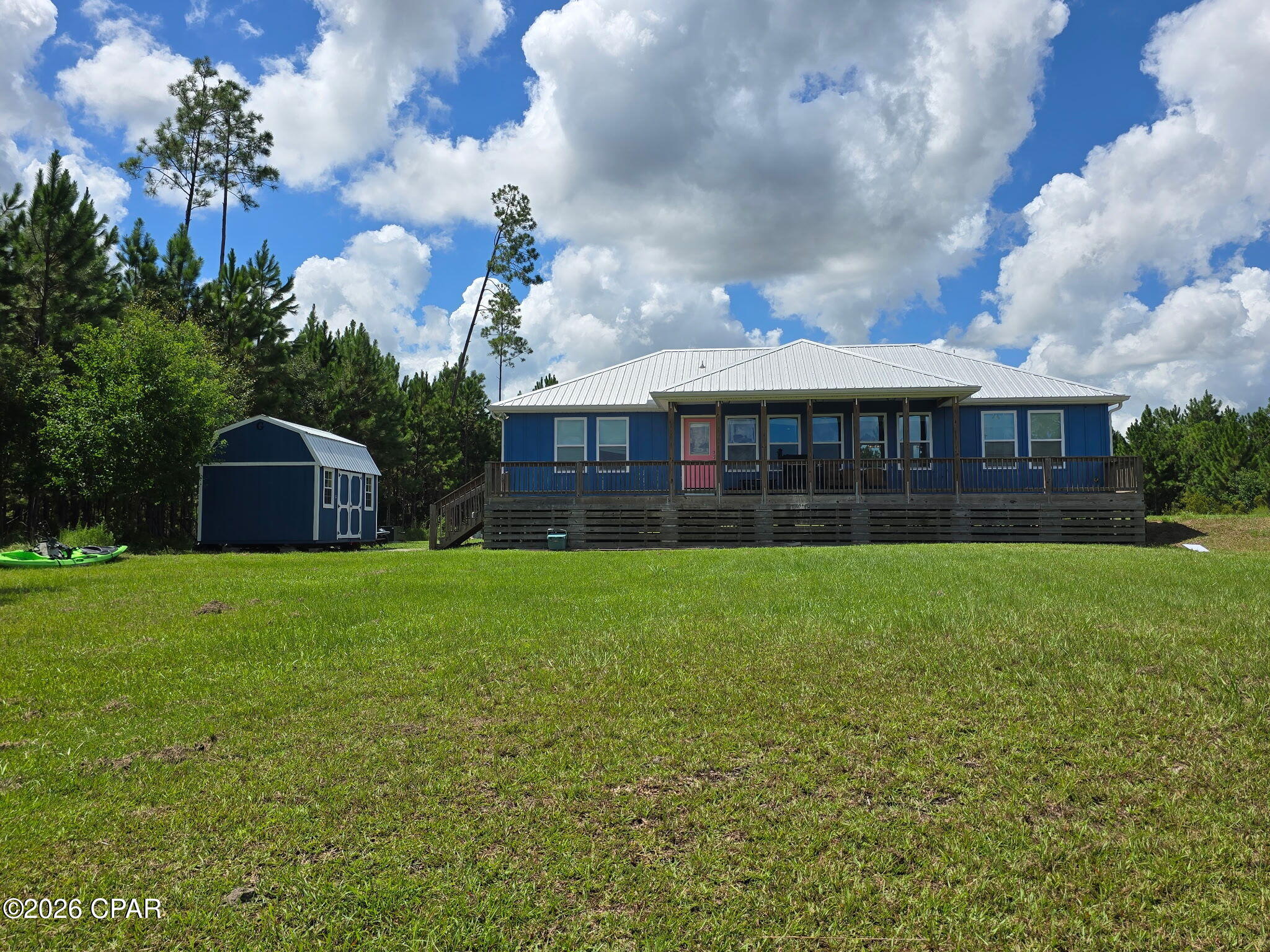 Enjoy peaceful Florida living in this custom-built, elevated cottage located in the gated Wetappo community of Wewahitchka.  Situated on 1.64 acres, this 3-bedroom, 2-bath home features new luxury vinyl flooring throughout, oak cabinetry, granite countertops, and appliances that convey with the sale.  Relax in the primary bedroom while enjoying a beautiful lake view.  Spray-foam insulation beneath the home adds energy efficiency. The spacious property offers plenty of room for pets, a garden, and outdoor activities.  Deer and rabbits are often seen in the yard from the nearby woods.   Community amenities include two lakes and a boat launch-perfect for enjoying the laid-back Florida lifestyle.