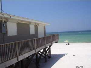 What an opportunity to live directly on the gulf in a lovely two bedroom, two bath beach home. Located by the curve on St. Thomas Drive, this home is convenient to local restaurants, shopping, entertainment and the beautiful St Andrews State Park. You have panoramic views of the beach and gulf through the multiple glass doors and the large open deck beyond. A kitchen island makes food prep a joy while watching the waves roll onto the shore. There are views of the beach from each bedroom. The master bedroom is quite large with a private bath. Bonus features are hurricane shutters and a yard building for additional storage. Don't miss this great opportunity to live directly on the gulf. There are very few long term rental houses directly on the sand - this one won't last long.
