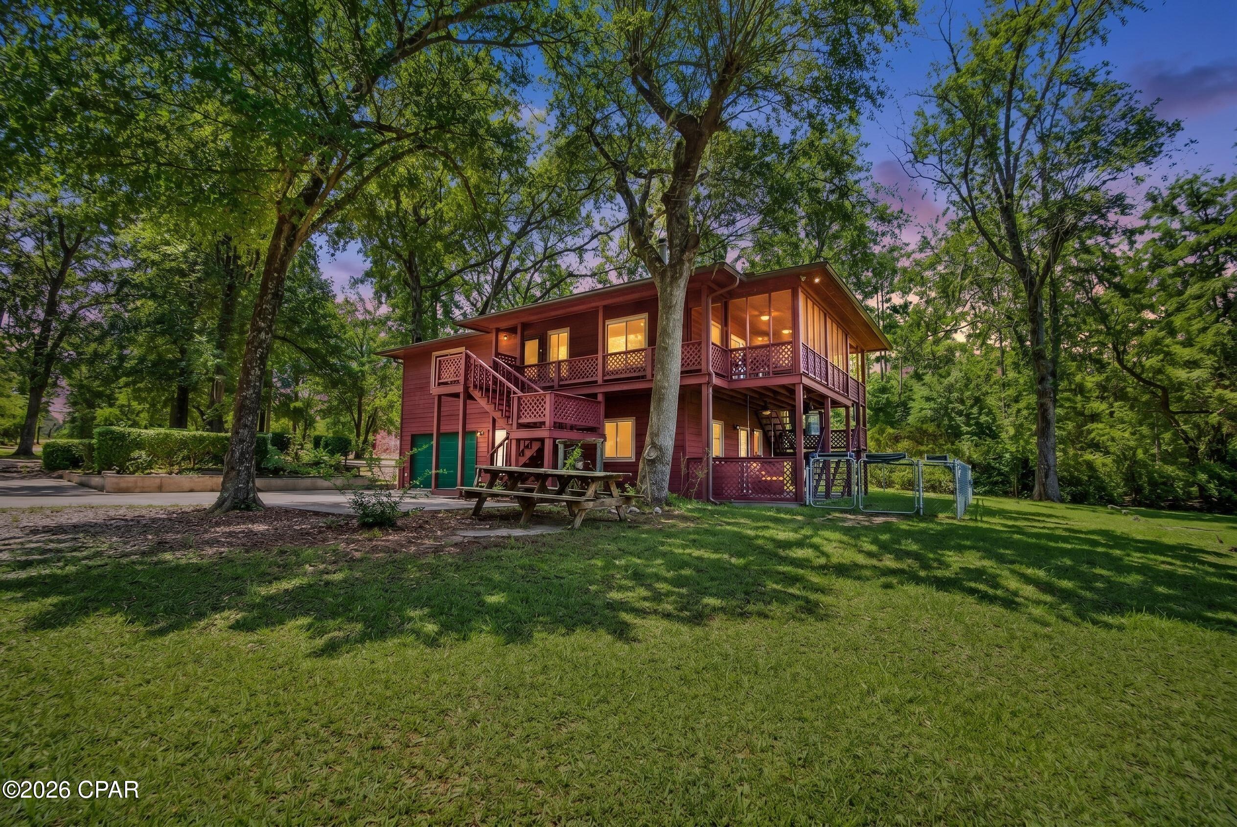 Welcome to your Ultimate Waterfront Compound on Silver Lake: Two Homes, Zero Compromise, with a brand new 19.5 SEER HVAC being installed in the main house July 31st.

Imagine waking up, walking out onto your upper-level balcony, and looking down to the crystal-clear, spring-fed water. No noise from roaring gas engines. No water pollution. Just absolute tranquility on the second-cleanest body of water in the entire state of Florida. 

Welcome to 3580 Seminole Lane, a rare 1.3-acre lakeside sanctuary spanning two premium, adjacent waterfront lots with 154 feet of pristine shoreline. Boasting NO HOA and featuring two completely independent residences totaling 2,126 square feet, this property offers the ultimate flexible layout: live seamlessly in one and generate premium short-term rental income on the other, multi-generational family compound living, or rent both for maximum yield. With short-term rental projections hitting $50,000+ annually, this is a turn-key cash-flowing asset as the region continues its rapid development over the next few years.

Step inside the main 3-bedroom, 2-bathroom custom cedar home and experience a warm, cabin aesthetic. The open-concept layout perfectly balances rustic charm with modern functionality, featuring durable luxury vinyl plank (LVP) flooring throughout the first level and rich hardwood styled LVP upstairs.

Just steps away sits the detached guest suite, a fully self-contained 1-bedroom efficiency equipped with a full kitchen, full bathroom, a cozy screened porch, and dedicated storage. 

This property features a high-capacity private well (2021) and septic systems mean no monthly city utility overhead. A whole home water filtration system was also installed in 2021. Two separate electrical meters on each house. A 2018 roof and impact-rated windows. An attached garage plus an expansive driveway and yard with plenty of parking for boats, jet skis, and RVs.

Unmatched Spring-Fed Lakefront Living:
Silver Lake is a private, 265-acre hidden gem. Because gas-powered motors are strictly prohibited, the ecosystem remains pristine, creating a mirror-like playground for swimming, kayaking, paddleboarding, and fishing. The outdoor oasis is entirely dialed in for entertainment: spend your afternoons on the private boat dock, launch from the dedicated kayak shack, or unwind in the massive lakeside BBQ pit area.

Whether you are searching for a short-term rental investment to capitalize on Jackson County's growth, a wellness retreat, or a private family compound, this turnkey waterfront estate is the sanctuary you've been waiting for. Opportunities on Silver Lake are rare, schedule your private tour today!